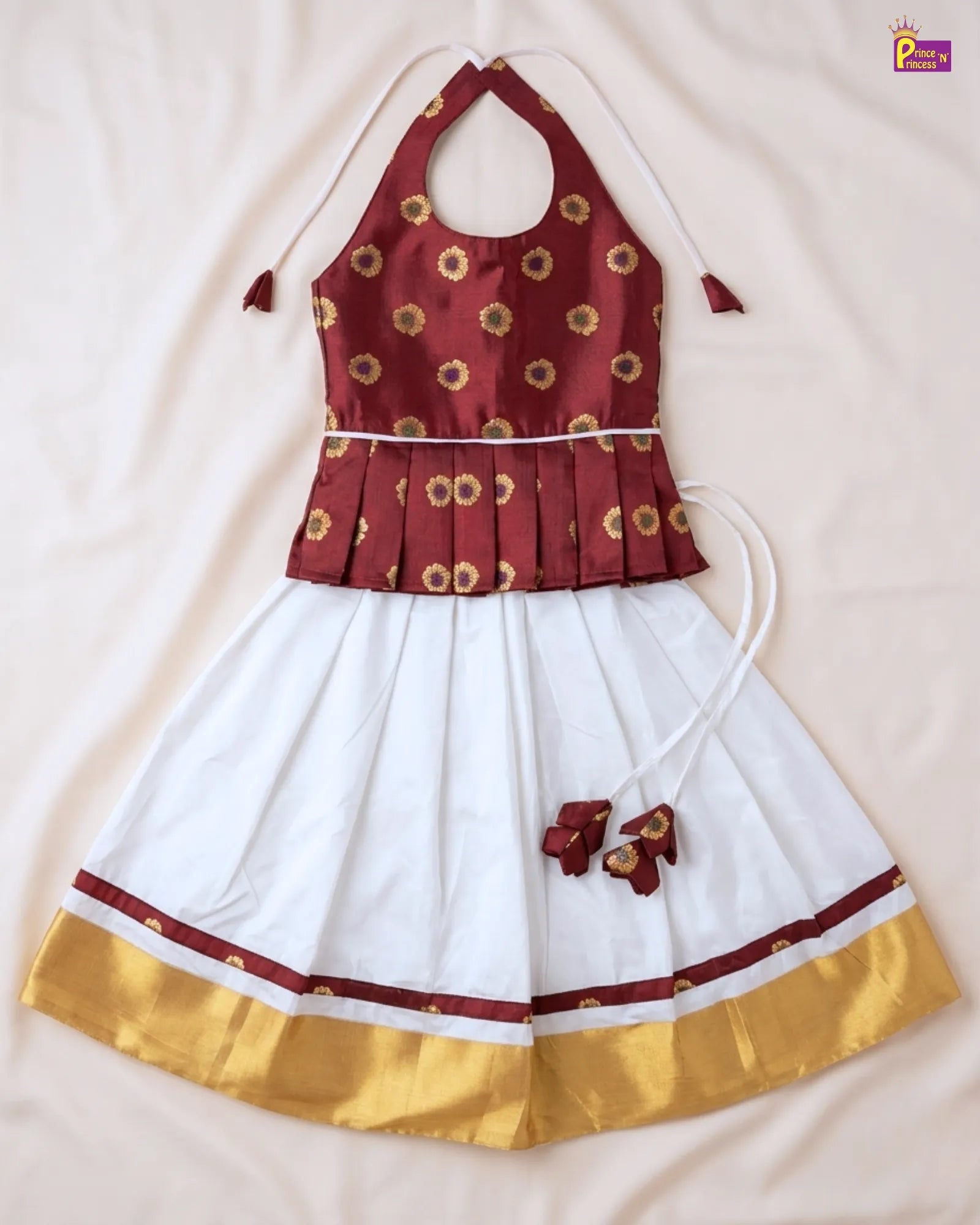 Red and white traditional outfit with gold accents on a beige background