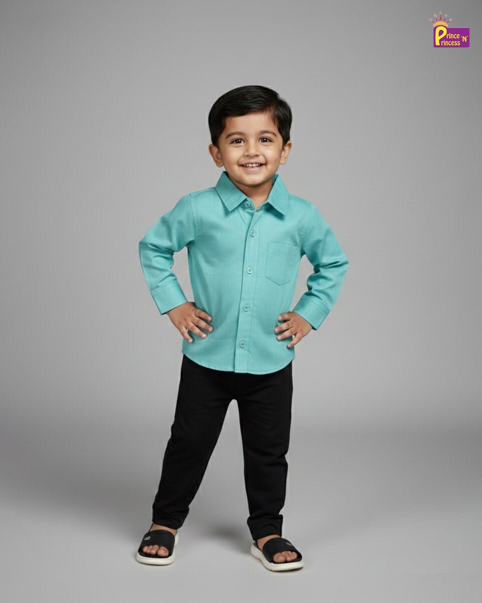 Child wearing a light blue shirt and black pants on a gray background - Prince N Princess