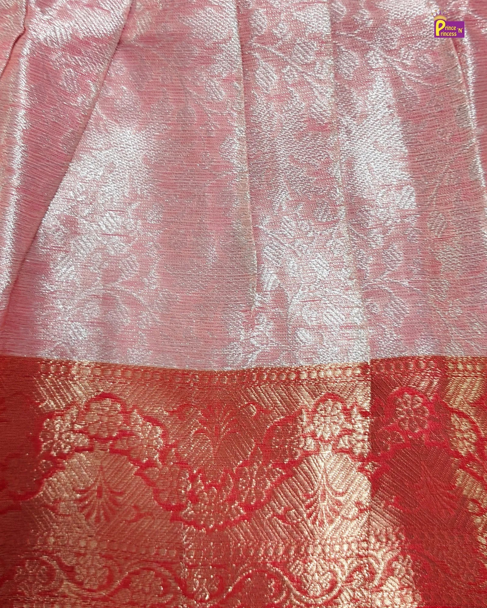 Close-up of a pink and red fabric with intricate patterns