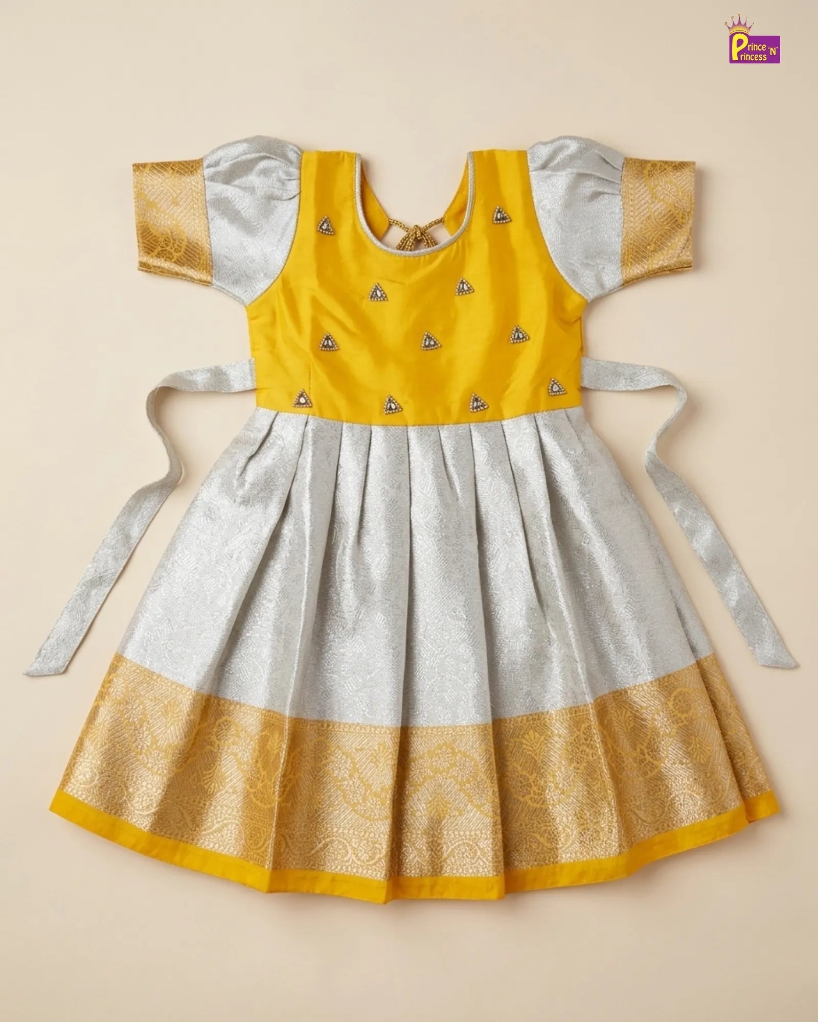 Yellow and gray traditional outfit with decorative elements on a beige background
