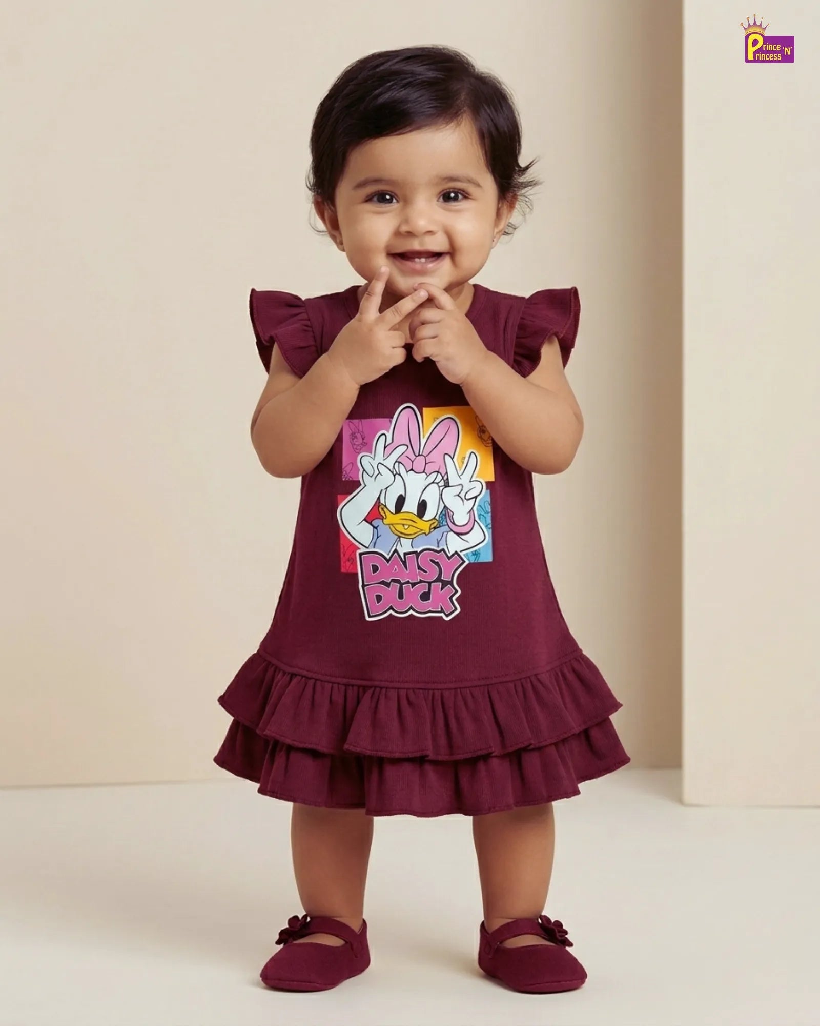 Child wearing a maroon dress with a cartoon character on a beige background