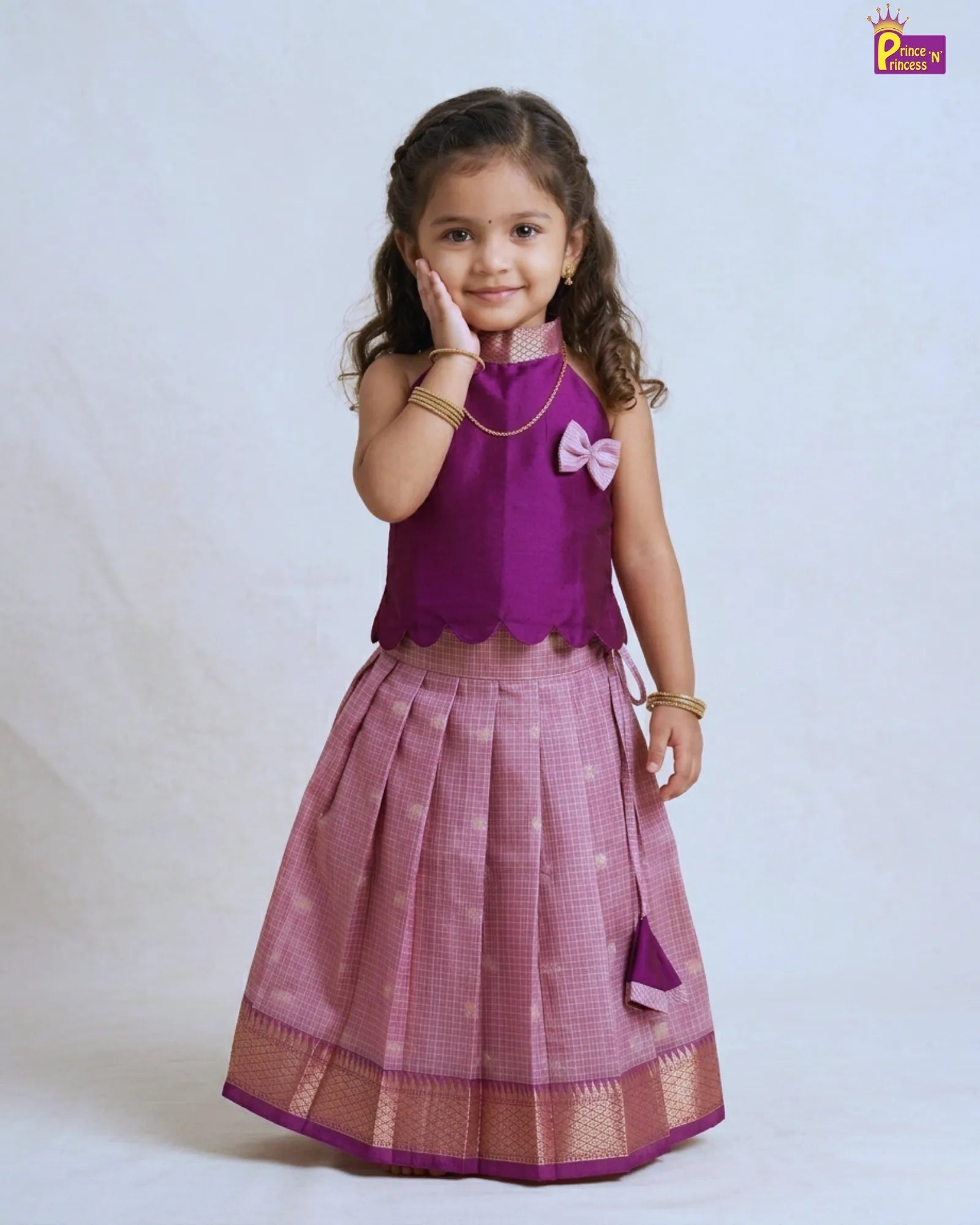 Girl wearing modern violet raw silk pattu pavadai traditional kids dress