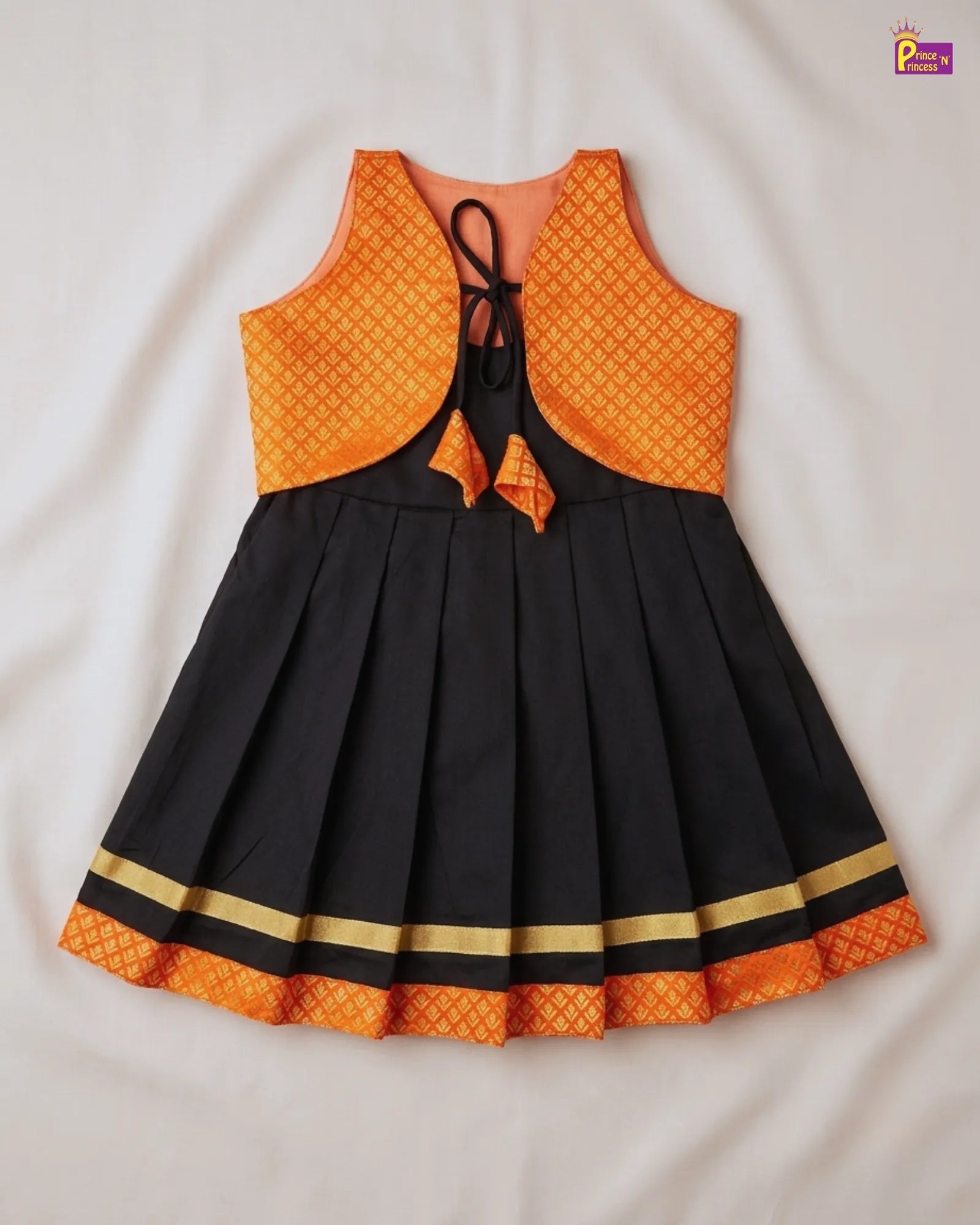 Black and orange dress with patterned top and skirt on a white background