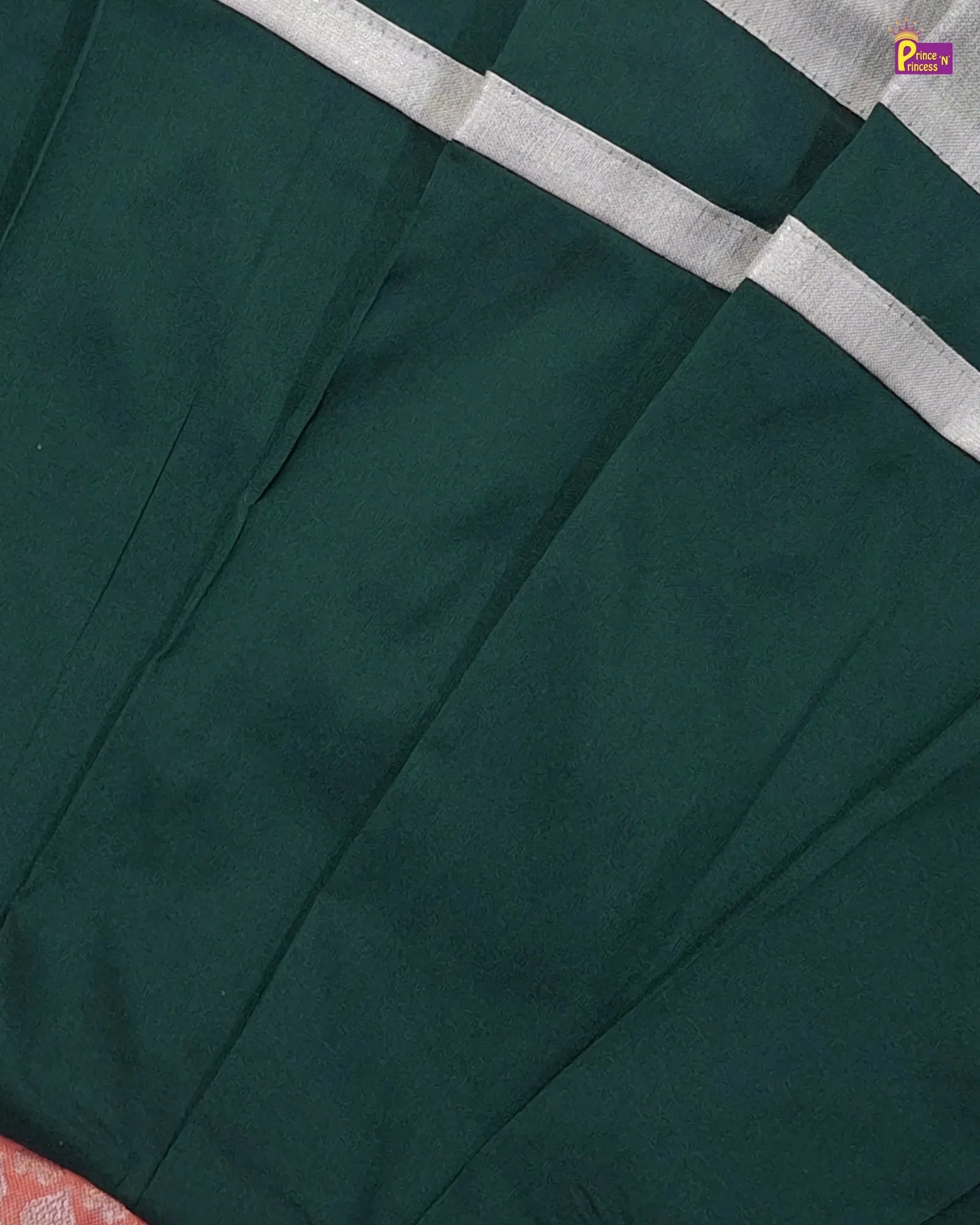 Close-up of a dark green fabric with a white border