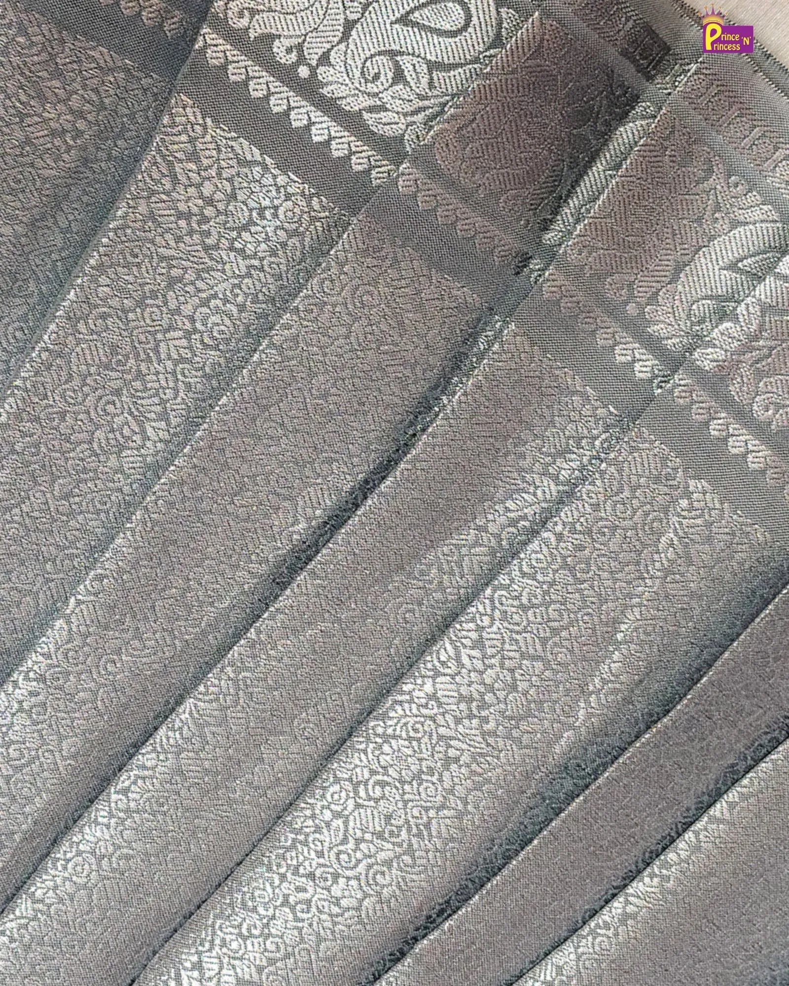 Close-up of a textured fabric with a pattern, likely a scarf or fabric swatch.