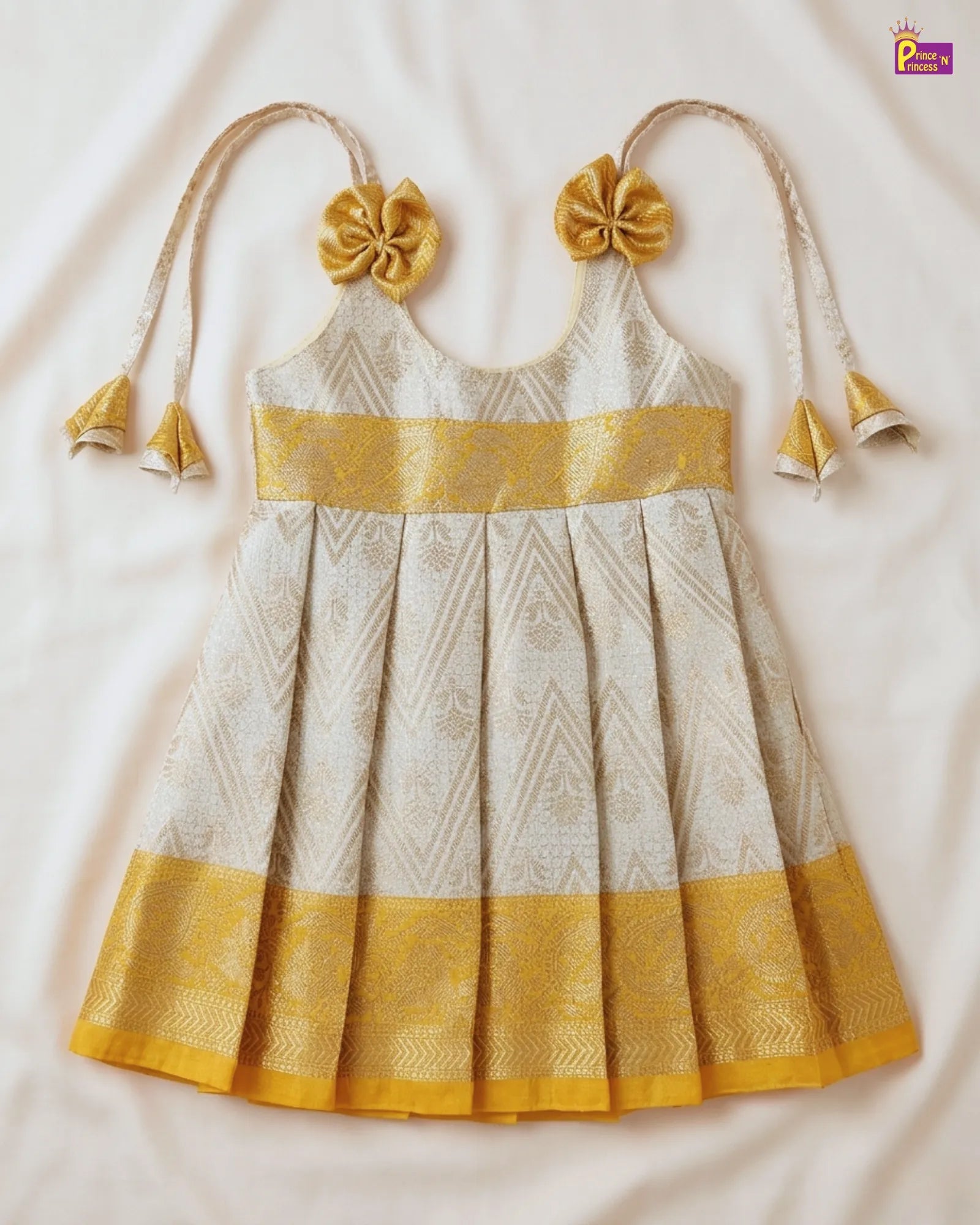 White and yellow traditional dress with floral details on a white background