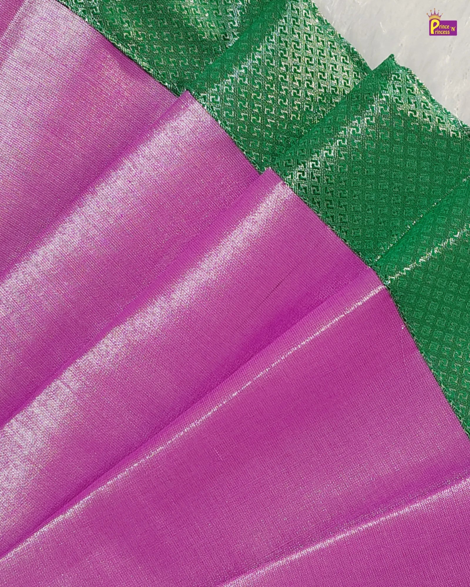 Close-up of purple fabric with green textured pattern