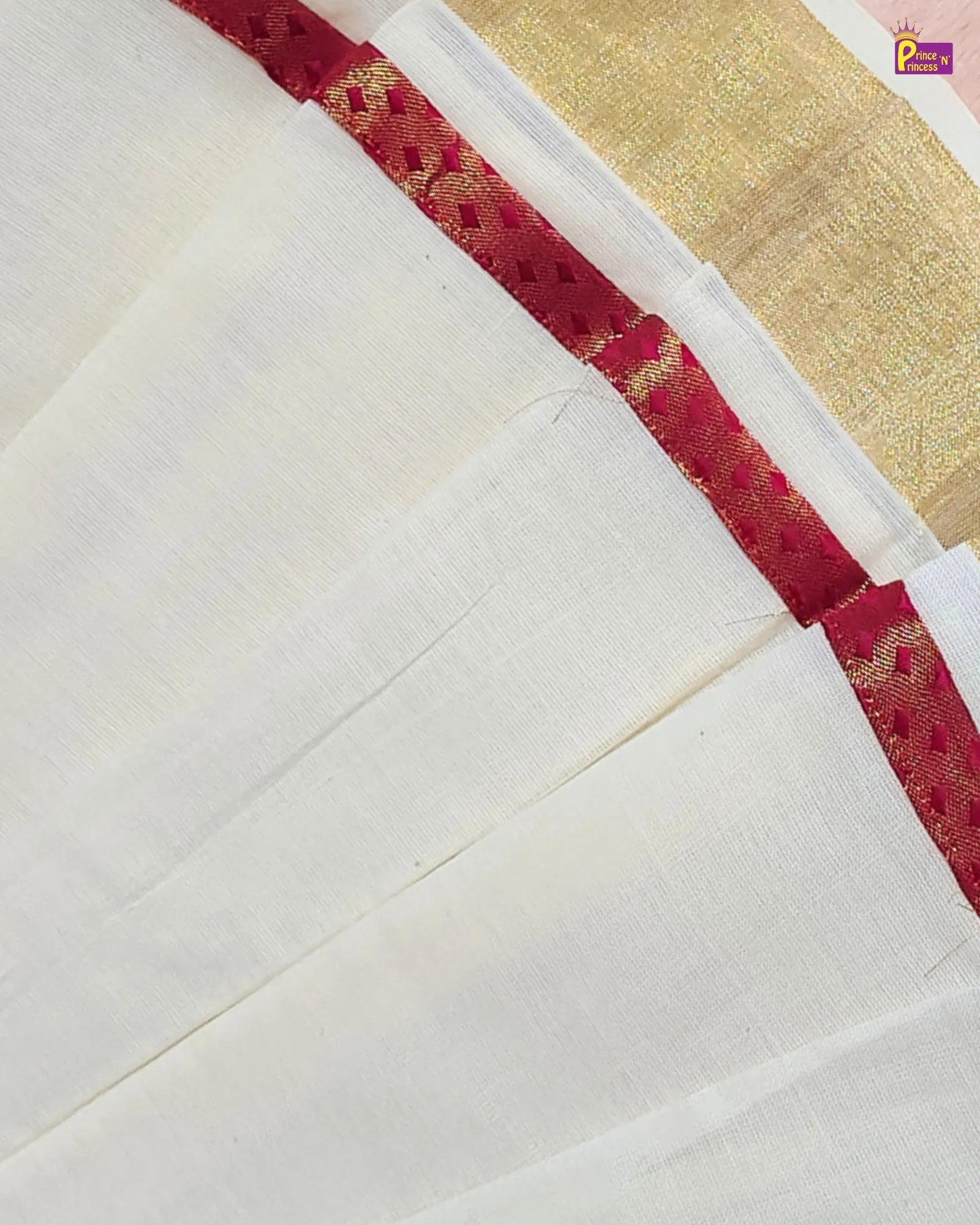 White fabric with red and gold border