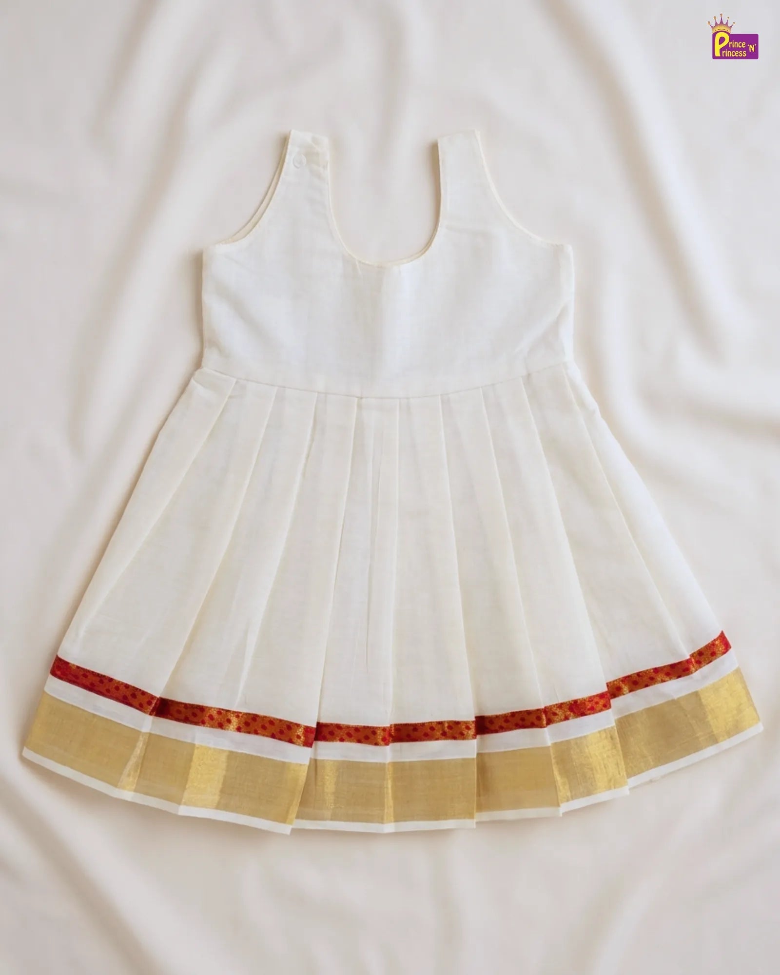 White dress with red and gold trim on a white background