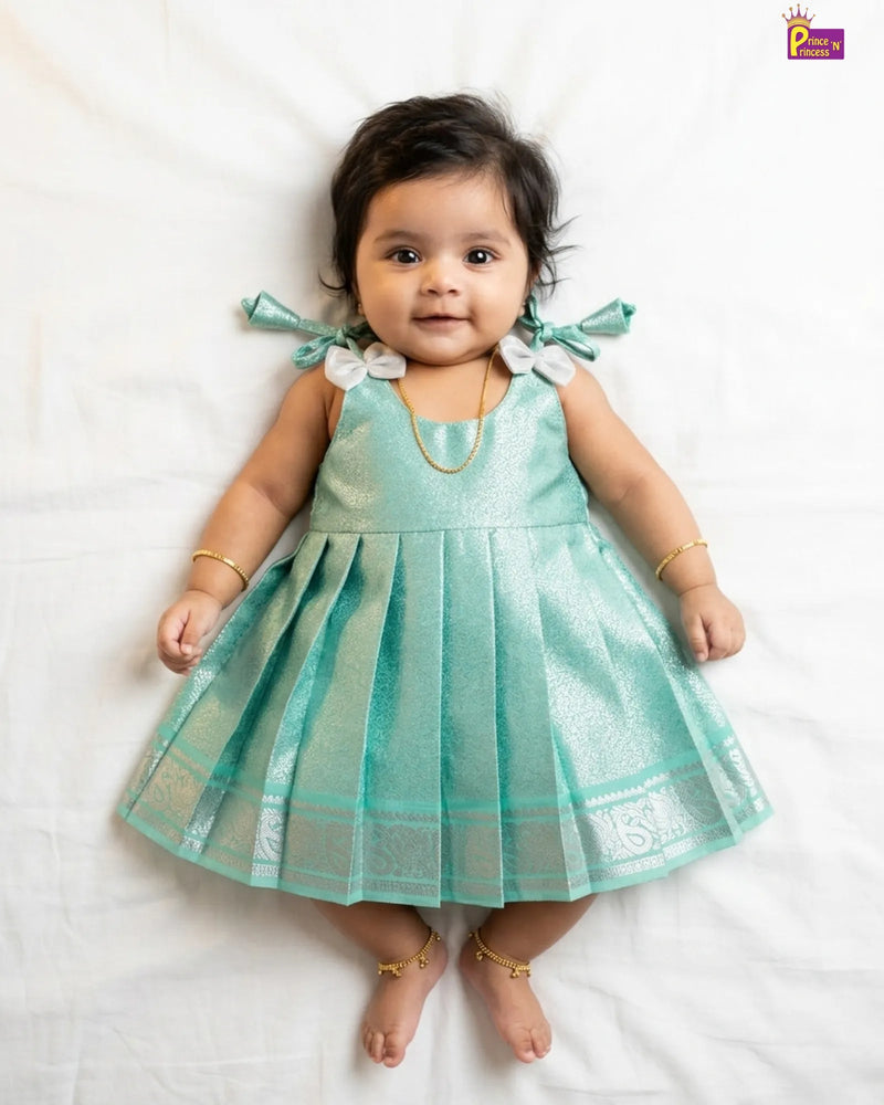 Newborn baby girl in mint teal silver gold zari brocade silk pattu frock with silver peacock Kanjivaram border by Prince N Princess naming ceremony
