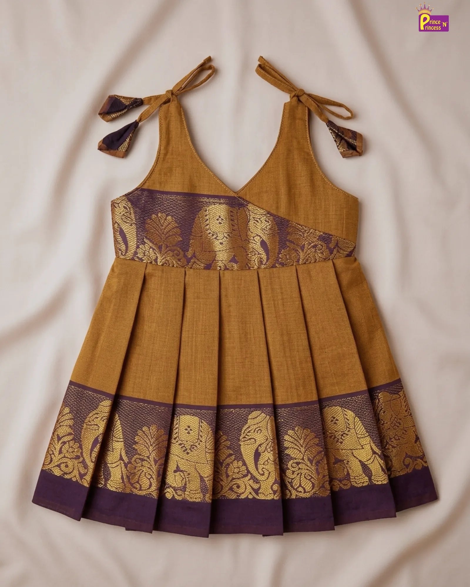 Close-up of a fabric with intricate gold pattern on a purple background