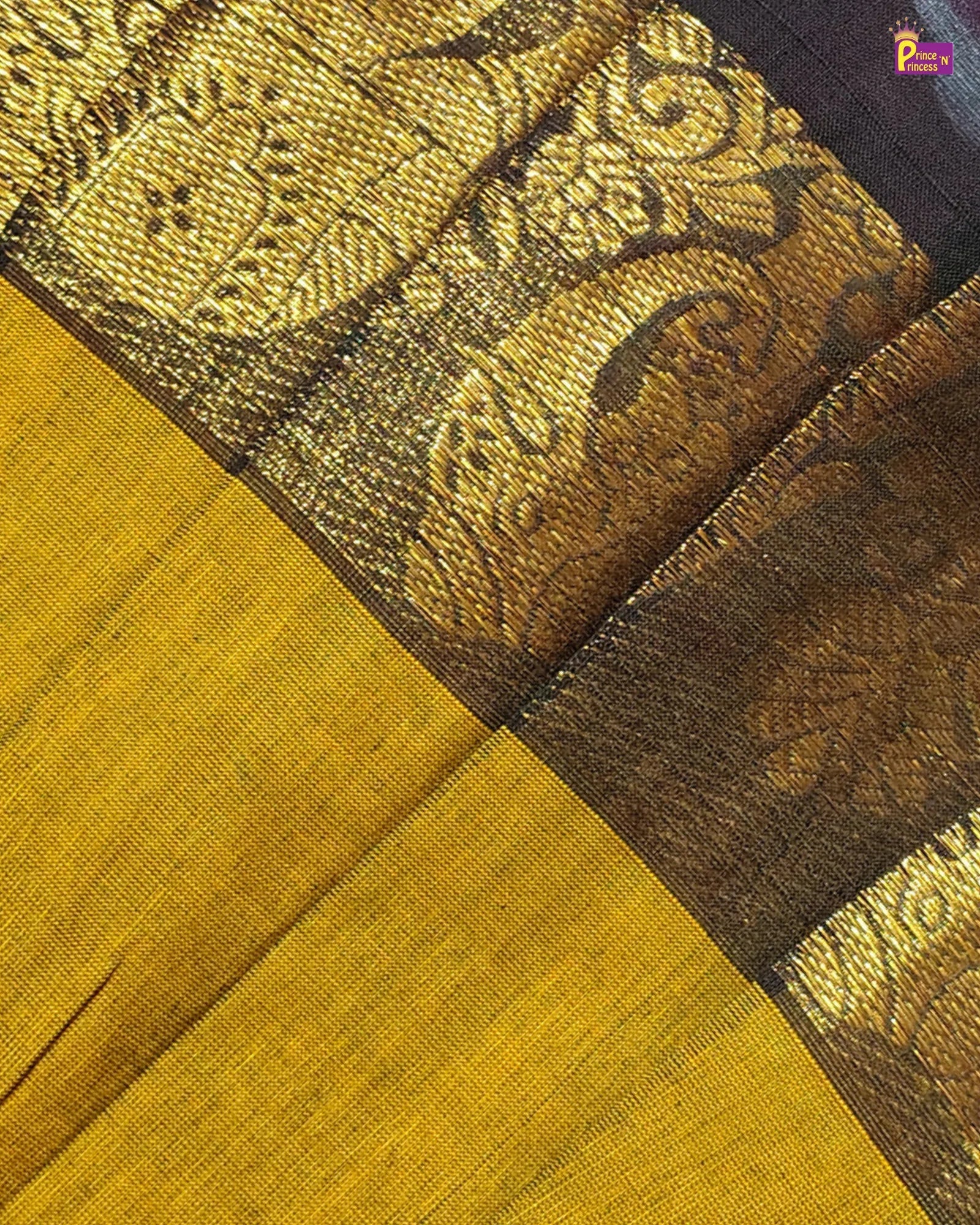 Close-up of a fabric with intricate patterns and colors, featuring a mix of brown and yellow.