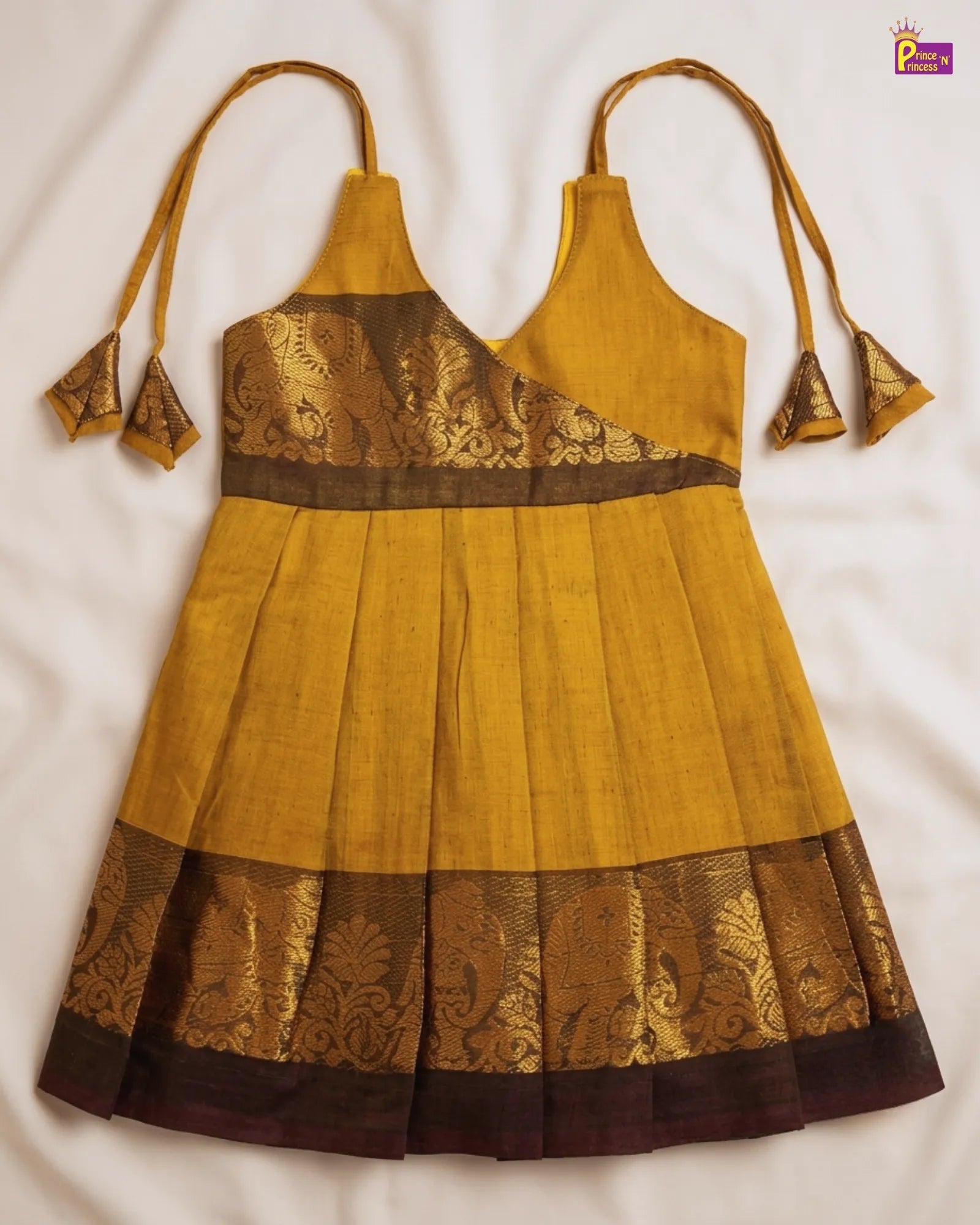 Yellow and brown traditional outfit with embroidered details on a white background