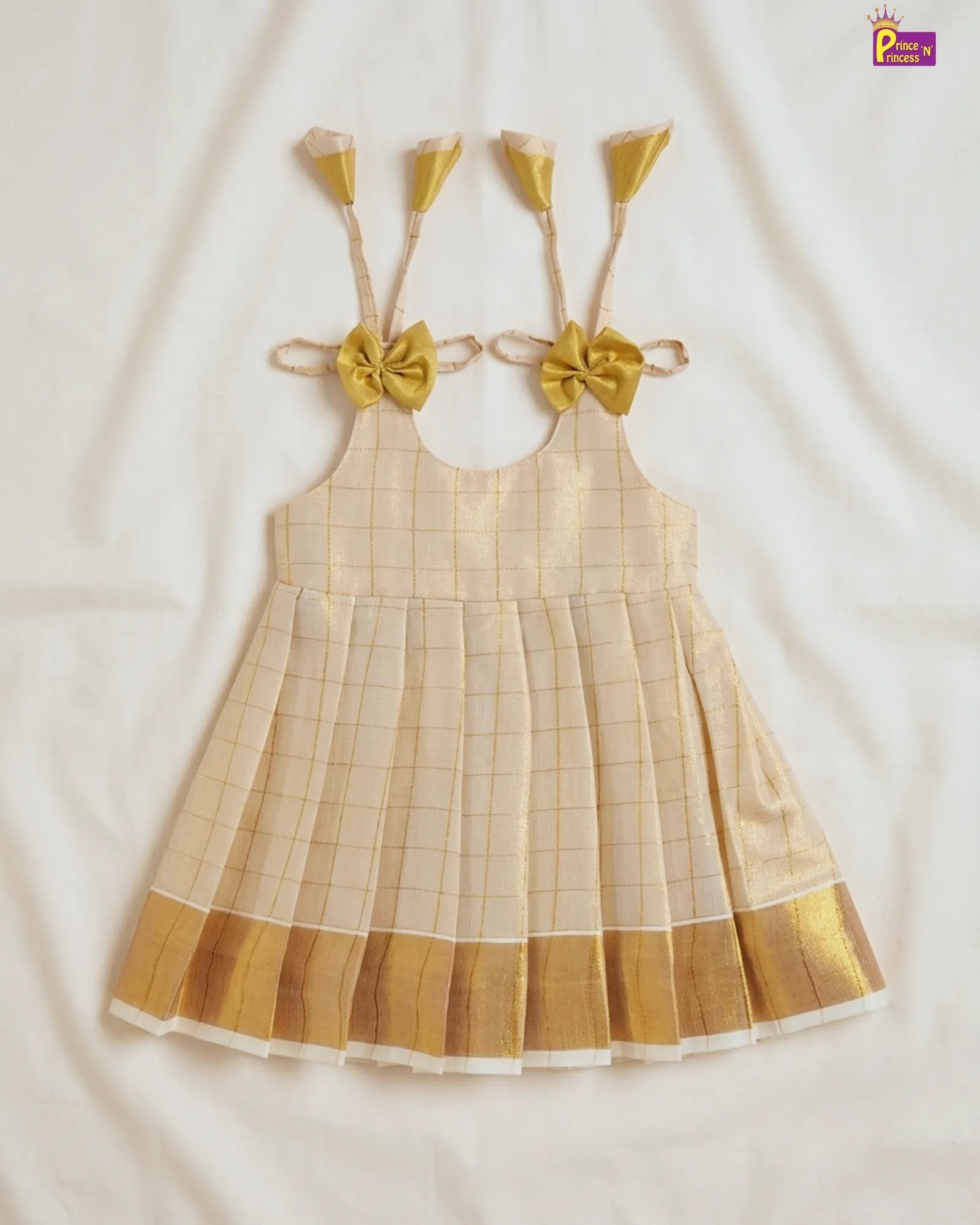 Beige checkered dress with gold accents on a white background