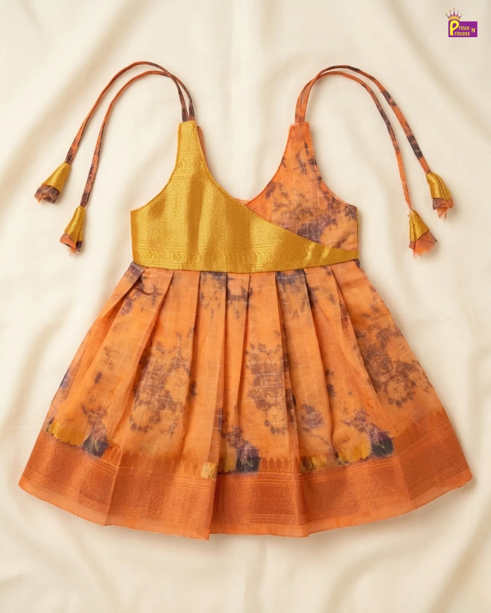 Orange and yellow dress with floral patterns on a beige background