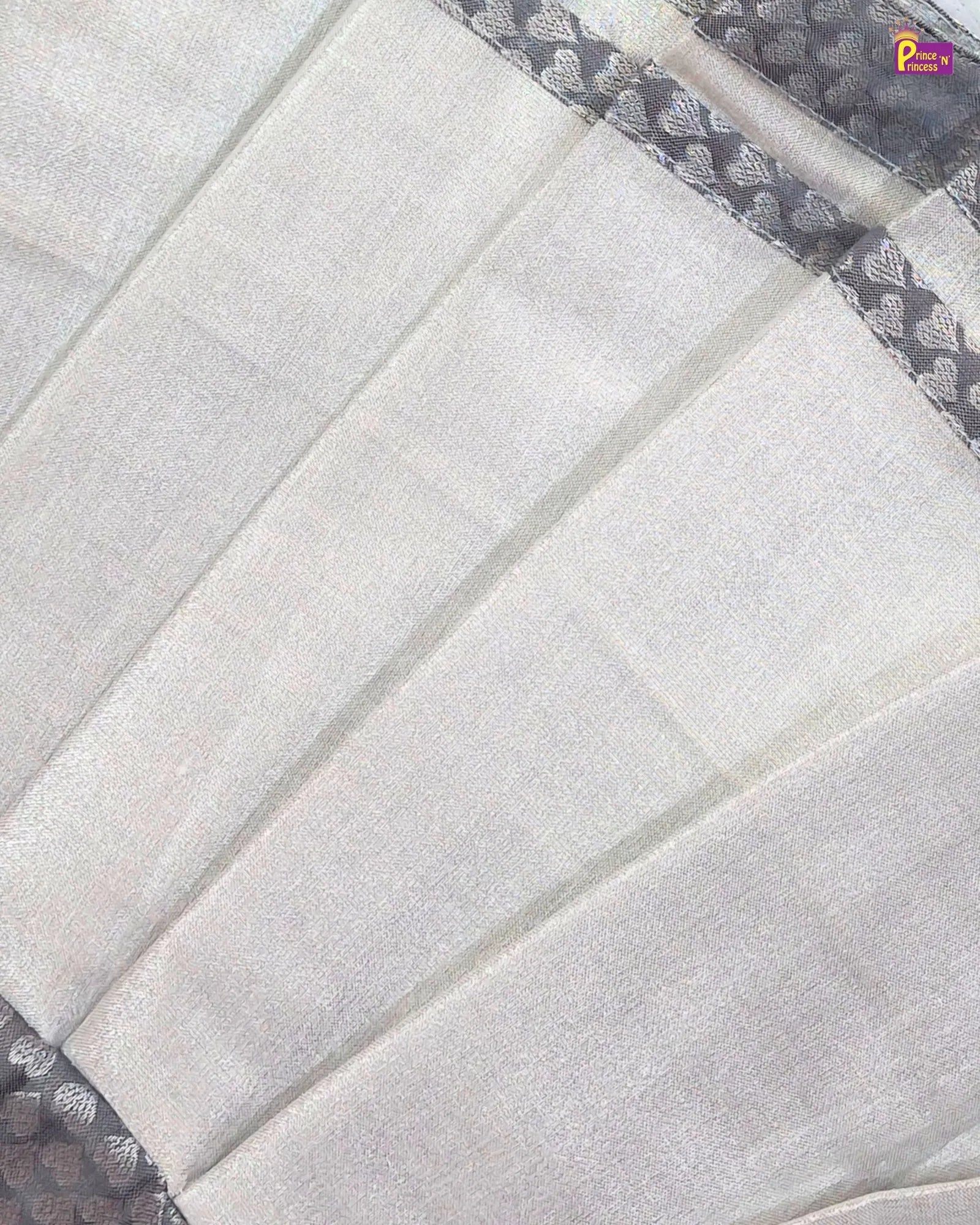Close-up of a quilt with a geometric pattern on a white background