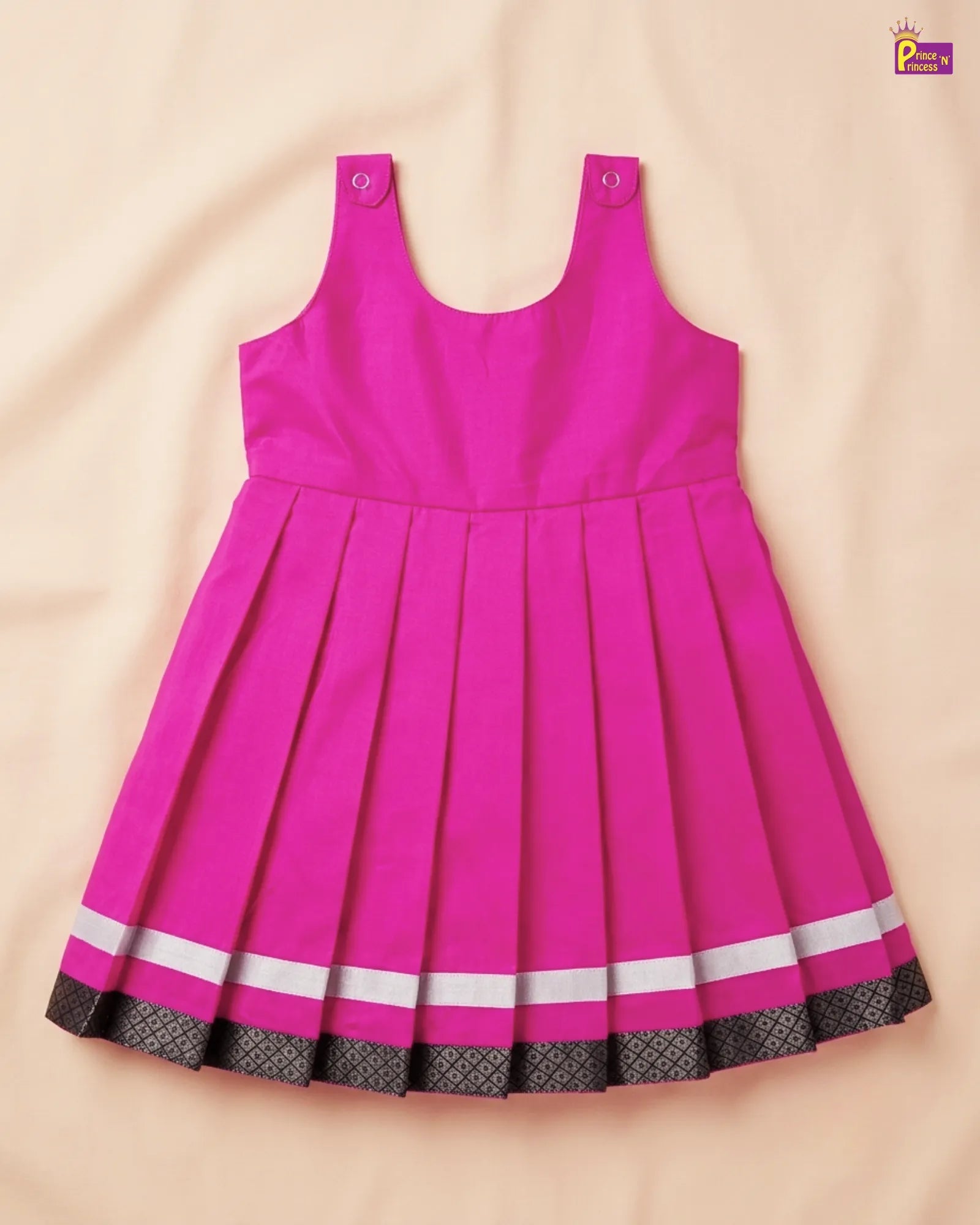 Pink dress with white and black trim on a beige background