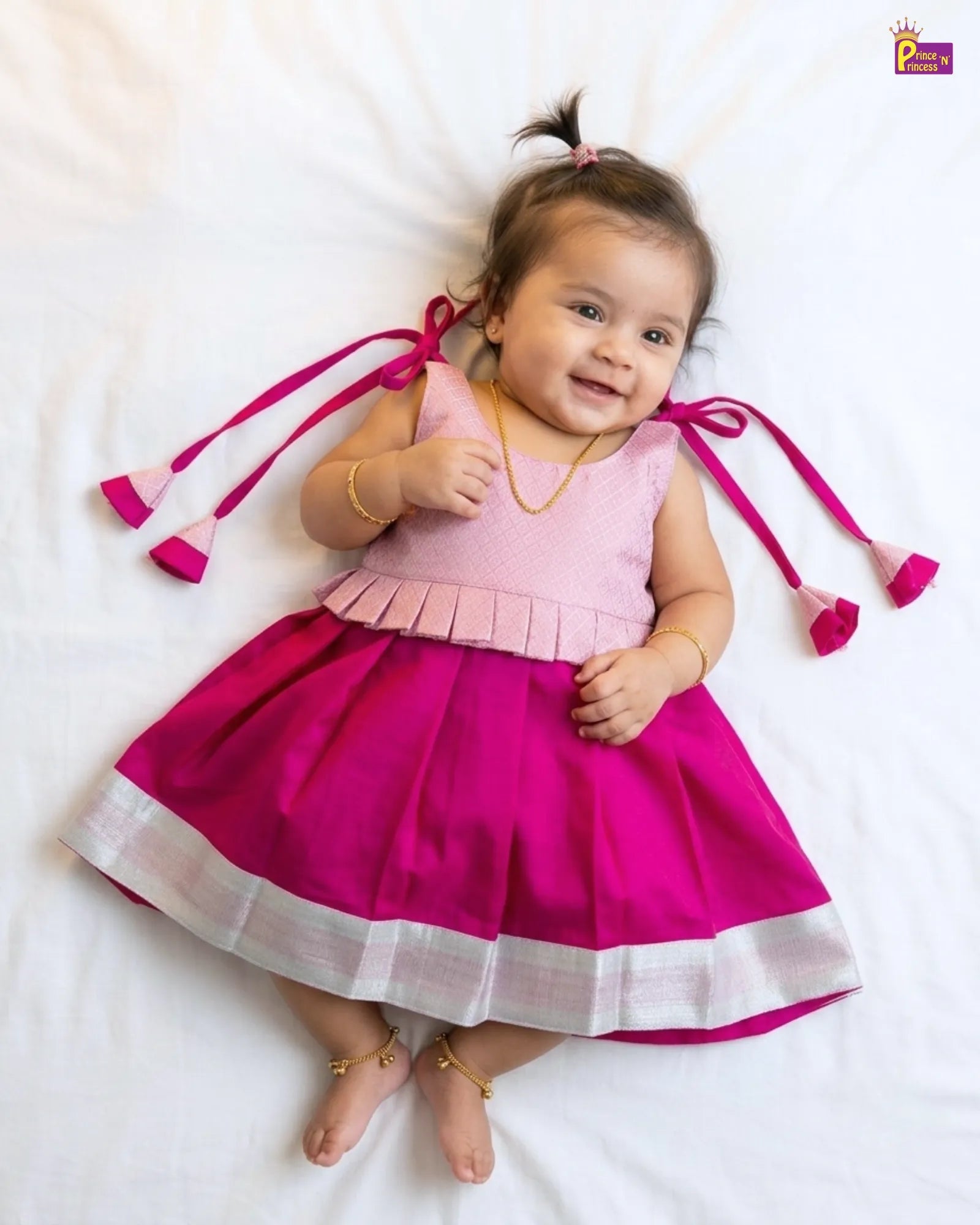 newborn baby wearing pink naming ceremony dress
