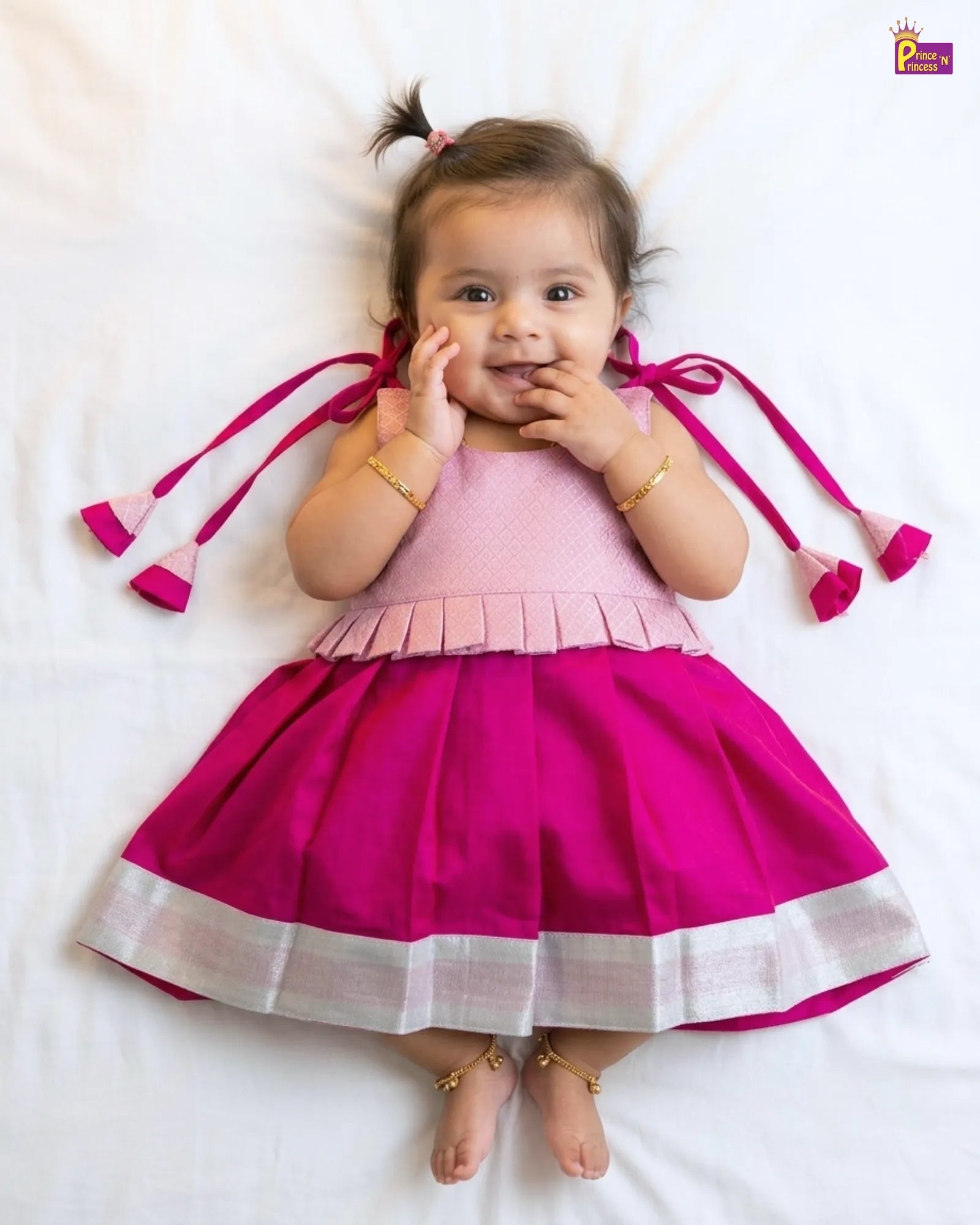 Newborn baby girl pink peplum pattu silk frock with a magenta pleated skirt and silver zari border princenprincess