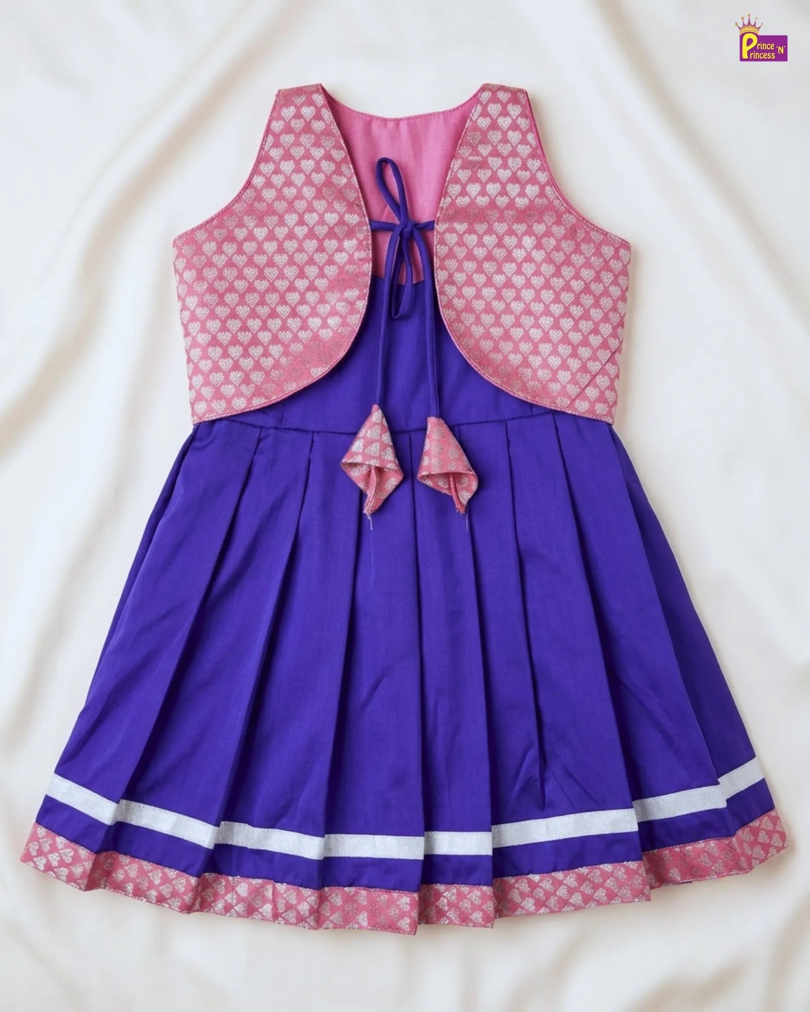 Purple dress with pink heart-patterned jacket on a white background