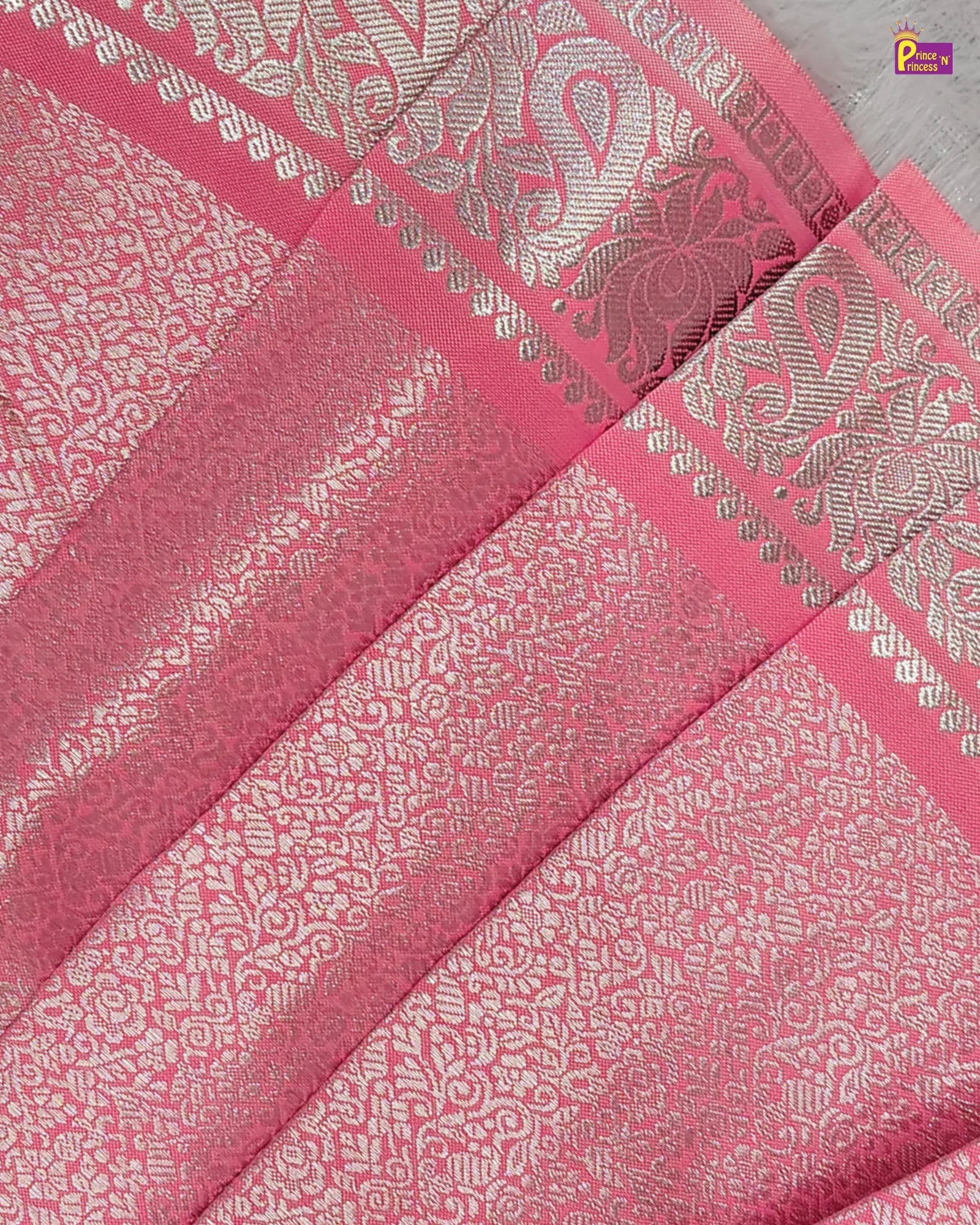 Pink fabric with silver patterns and a brand logo in the corner.