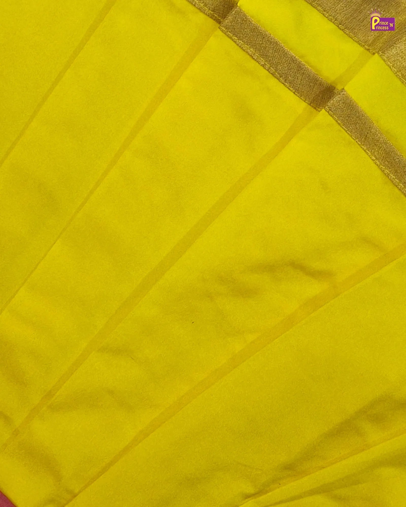 Close-up of a yellow fabric with a gold border