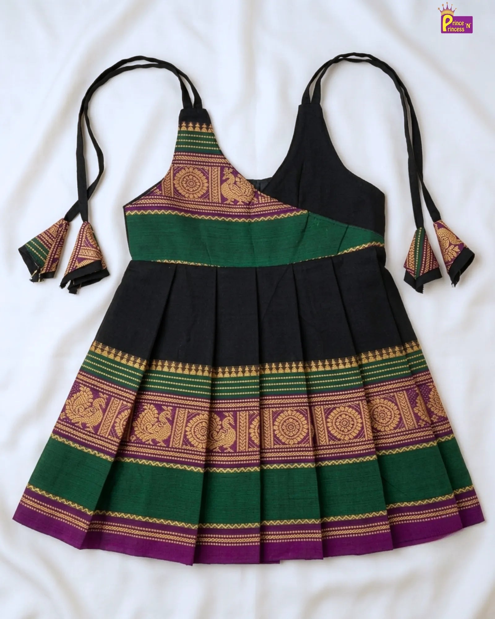 Black and green dress with gold patterns on a white background