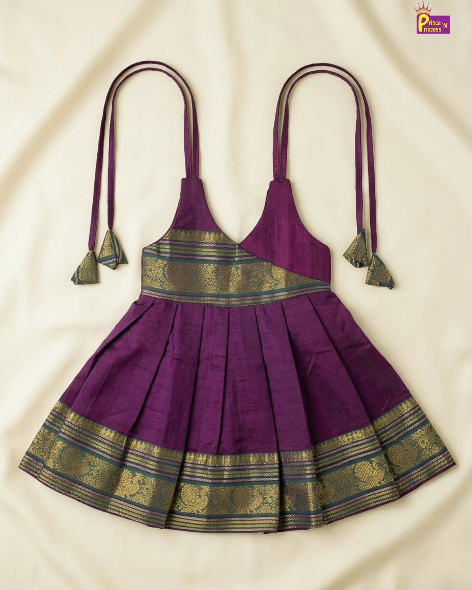 Purple dress with gold accents on a beige background