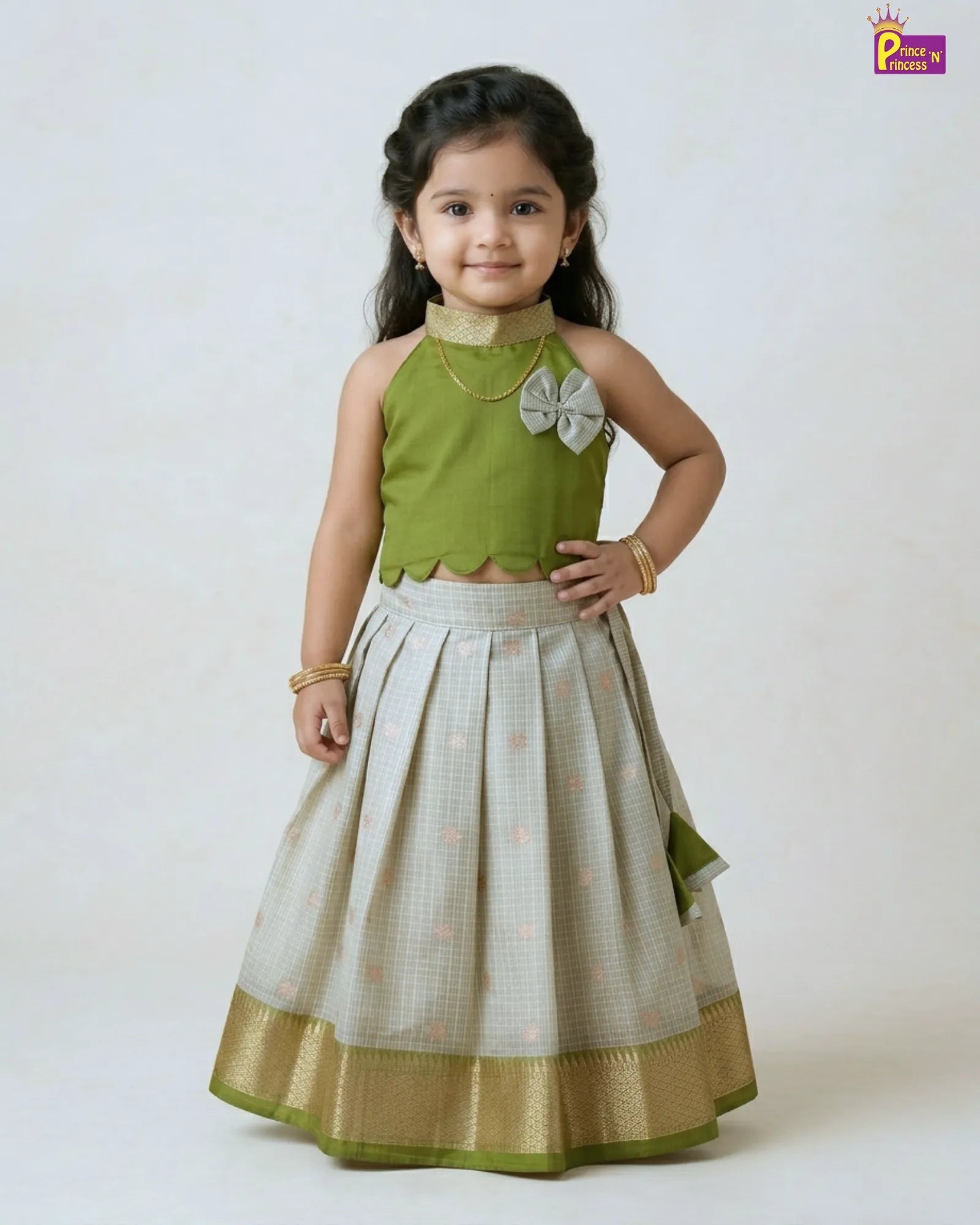 Girl wearing olive green raw silk pattu pavadai traditional kids ethnic dress