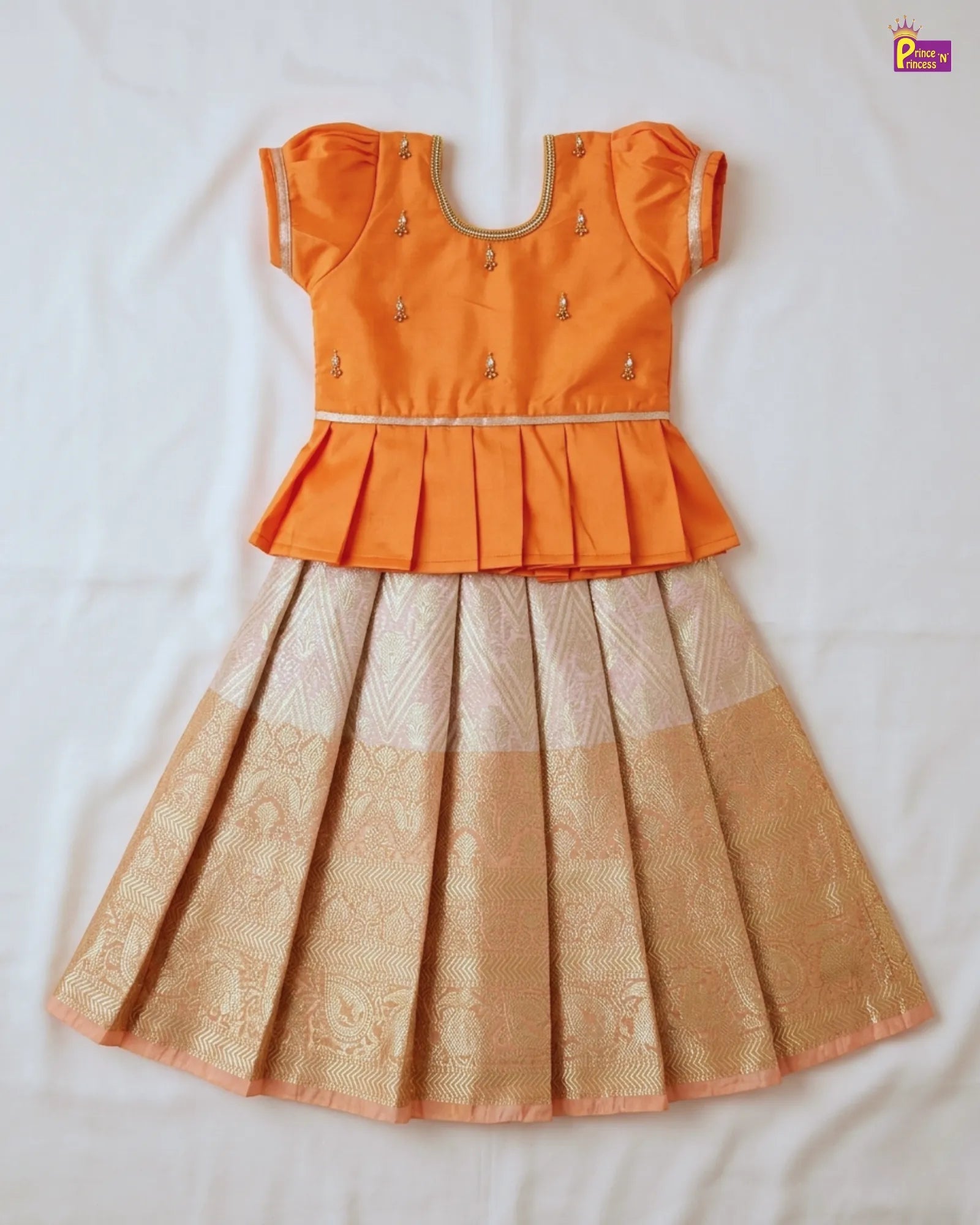 Orange top and beige skirt set on a white background