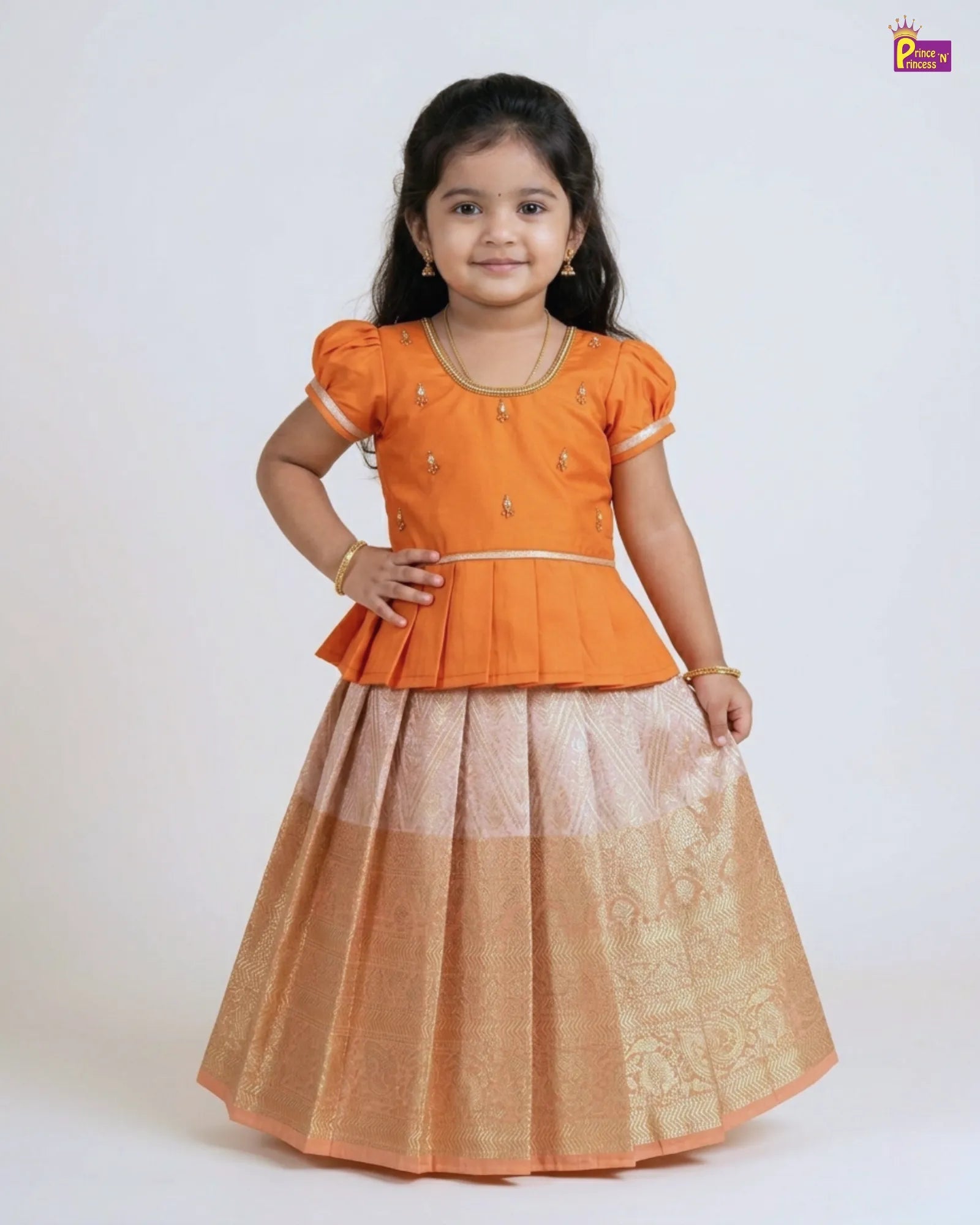 Young girl wearing an orange top and beige skirt on a white background