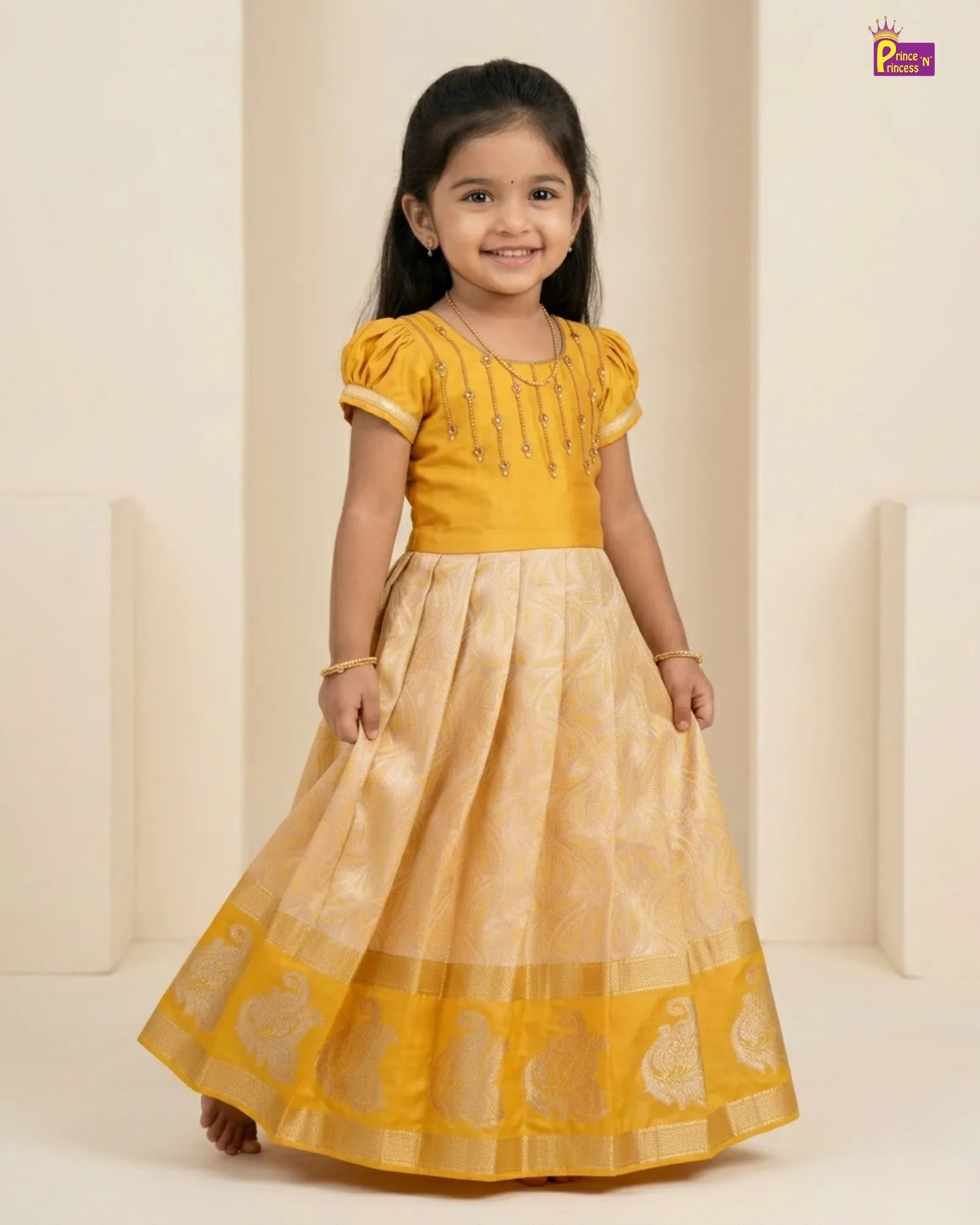 Young girl wearing a yellow traditional outfit with a beige background