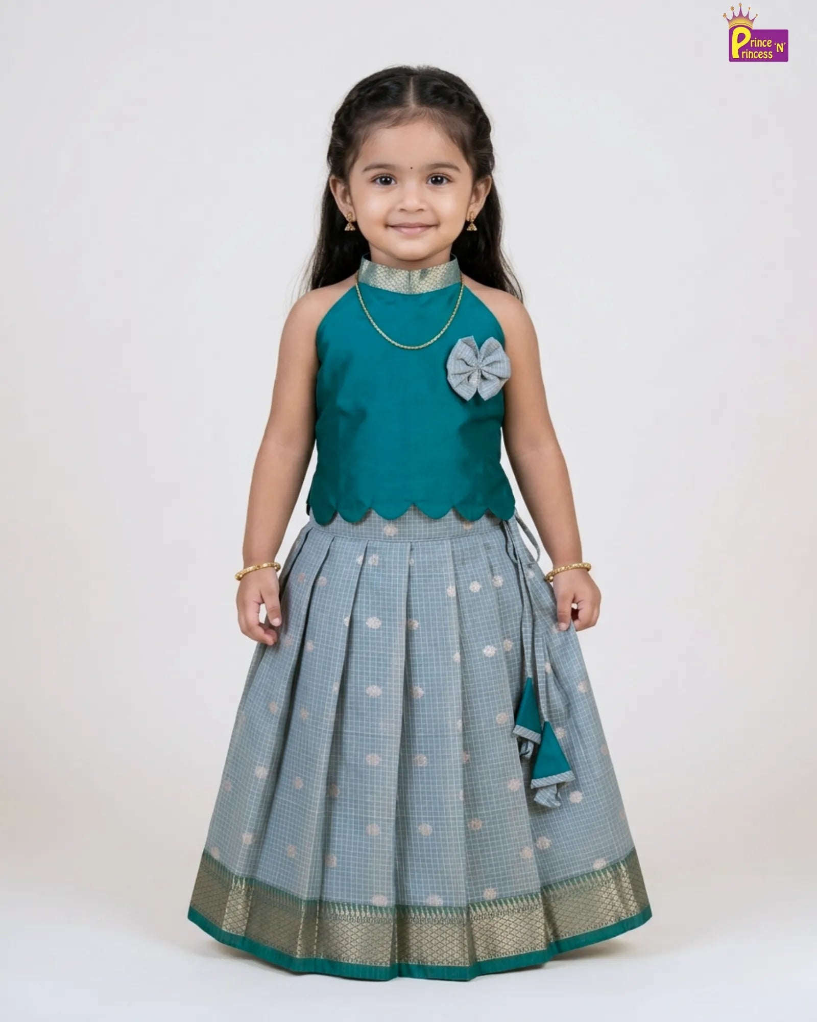 Girl wearing Rama green raw silk Pattu Pavadai with silver skirt and gold border traditional kids dress