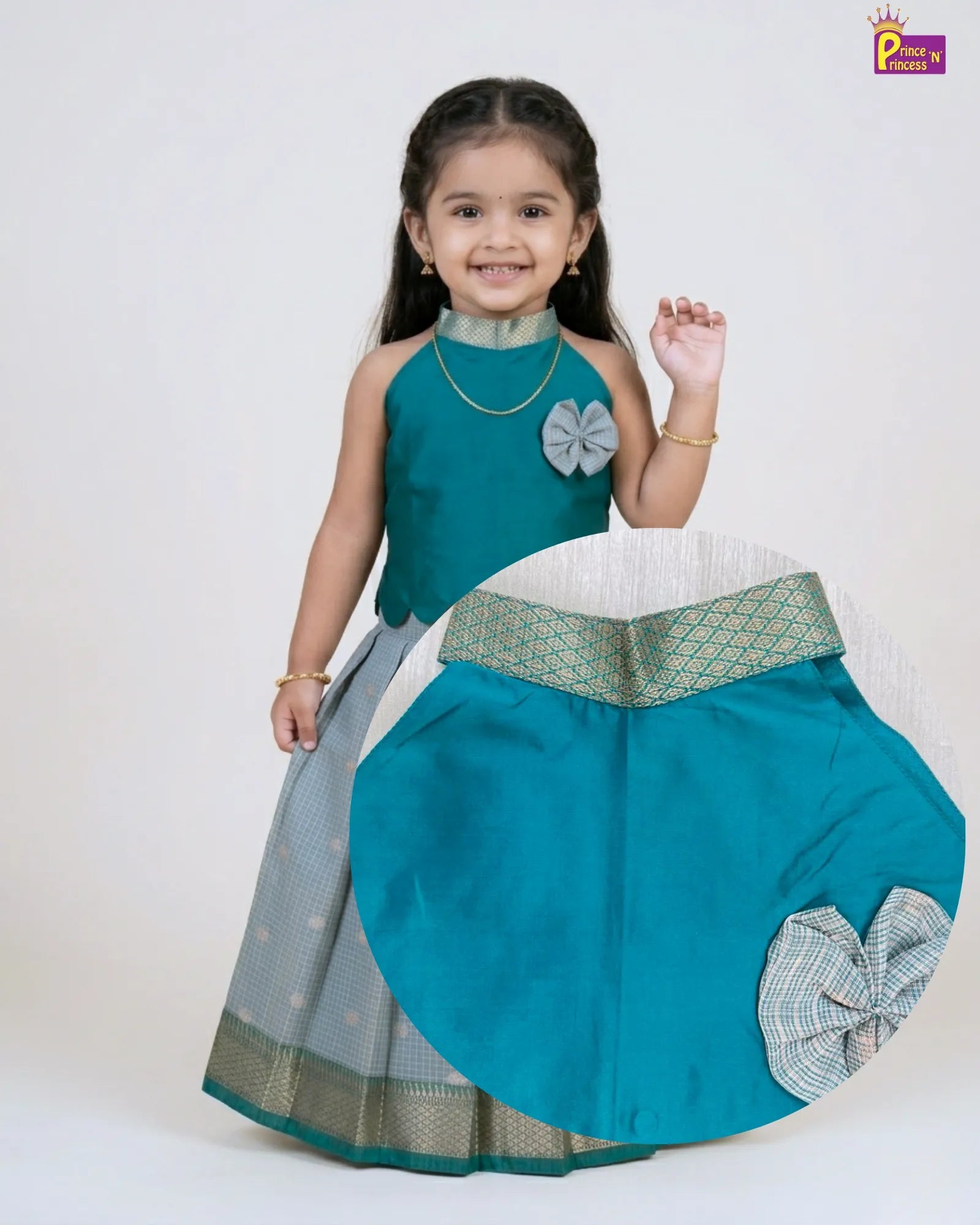 Girl wearing Rama green raw silk Pattu Pavadai with silver skirt and gold border traditional kids dress