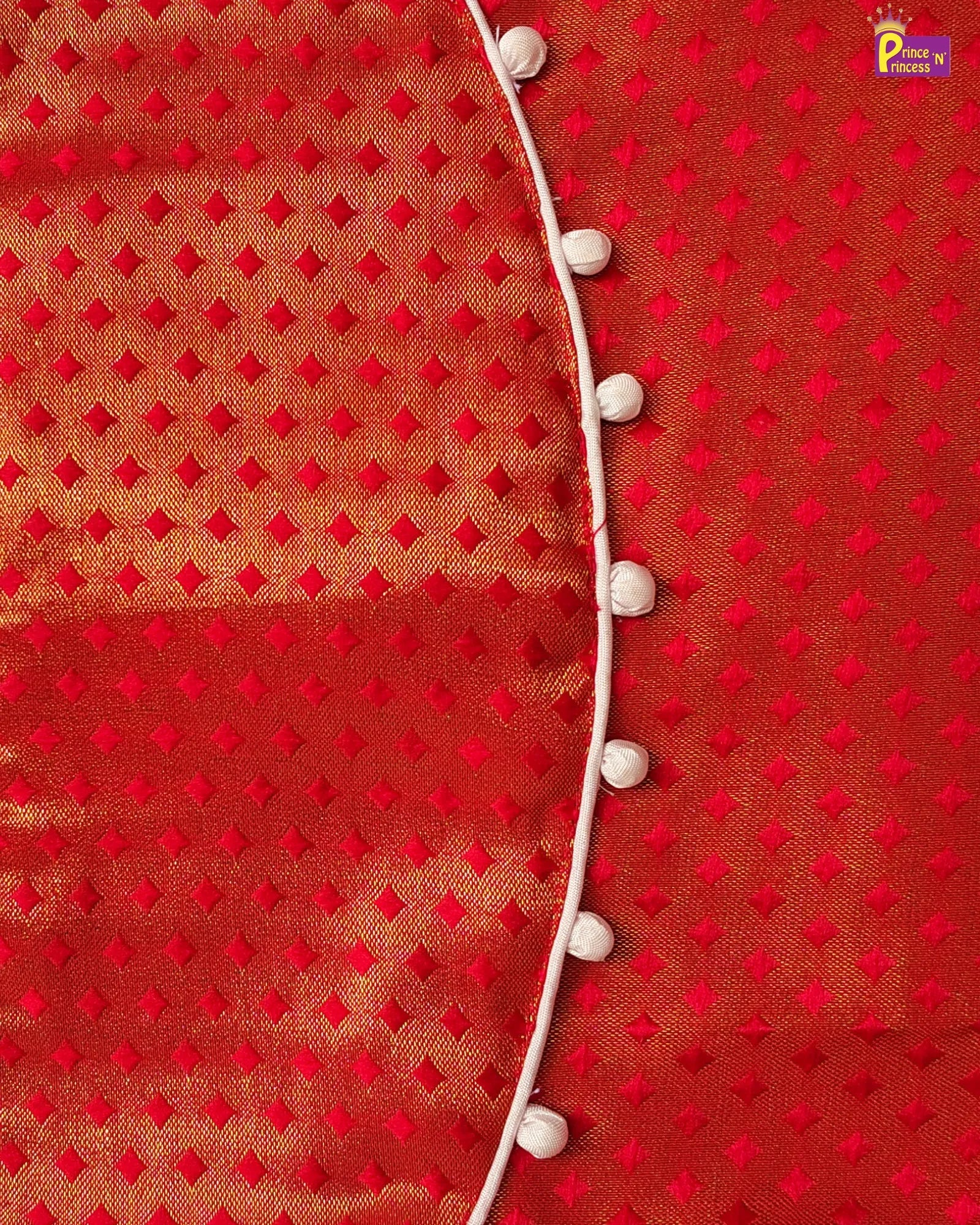 Red fabric with white diamond pattern and decorative buttons on a red background