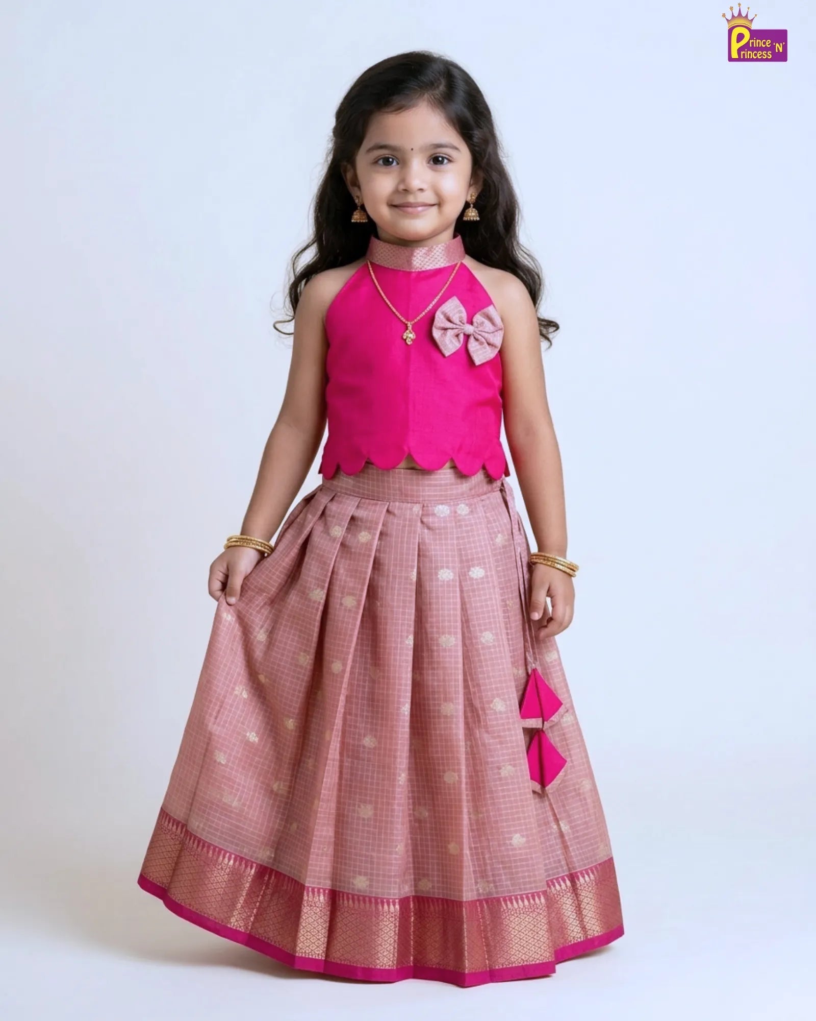 Girl wearing pink raw silk Pattu Pavadai with silver skirt and gold border traditional kids festive wear