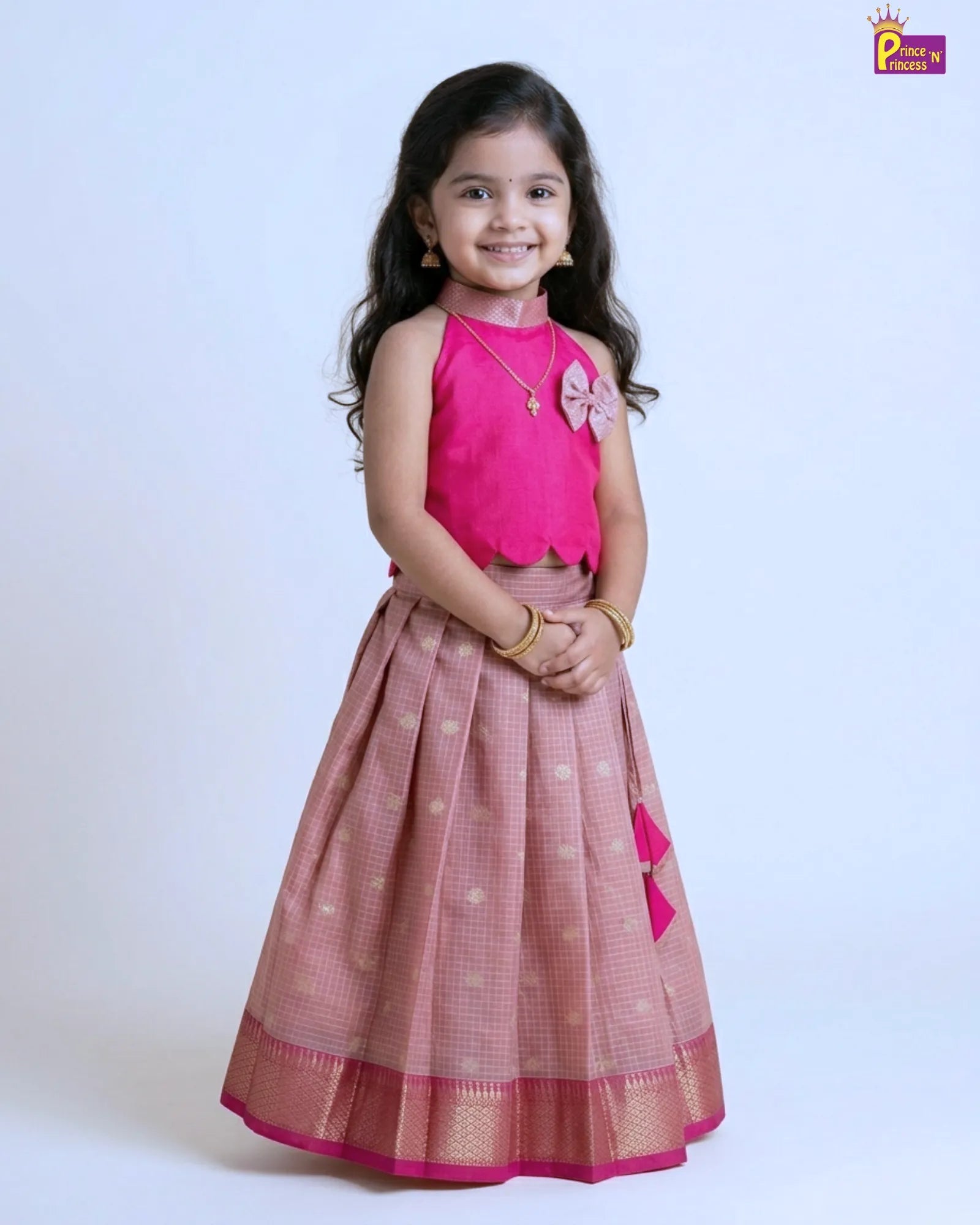 Girl wearing pink raw silk Pattu Pavadai with silver skirt and gold border traditional kids festive wear