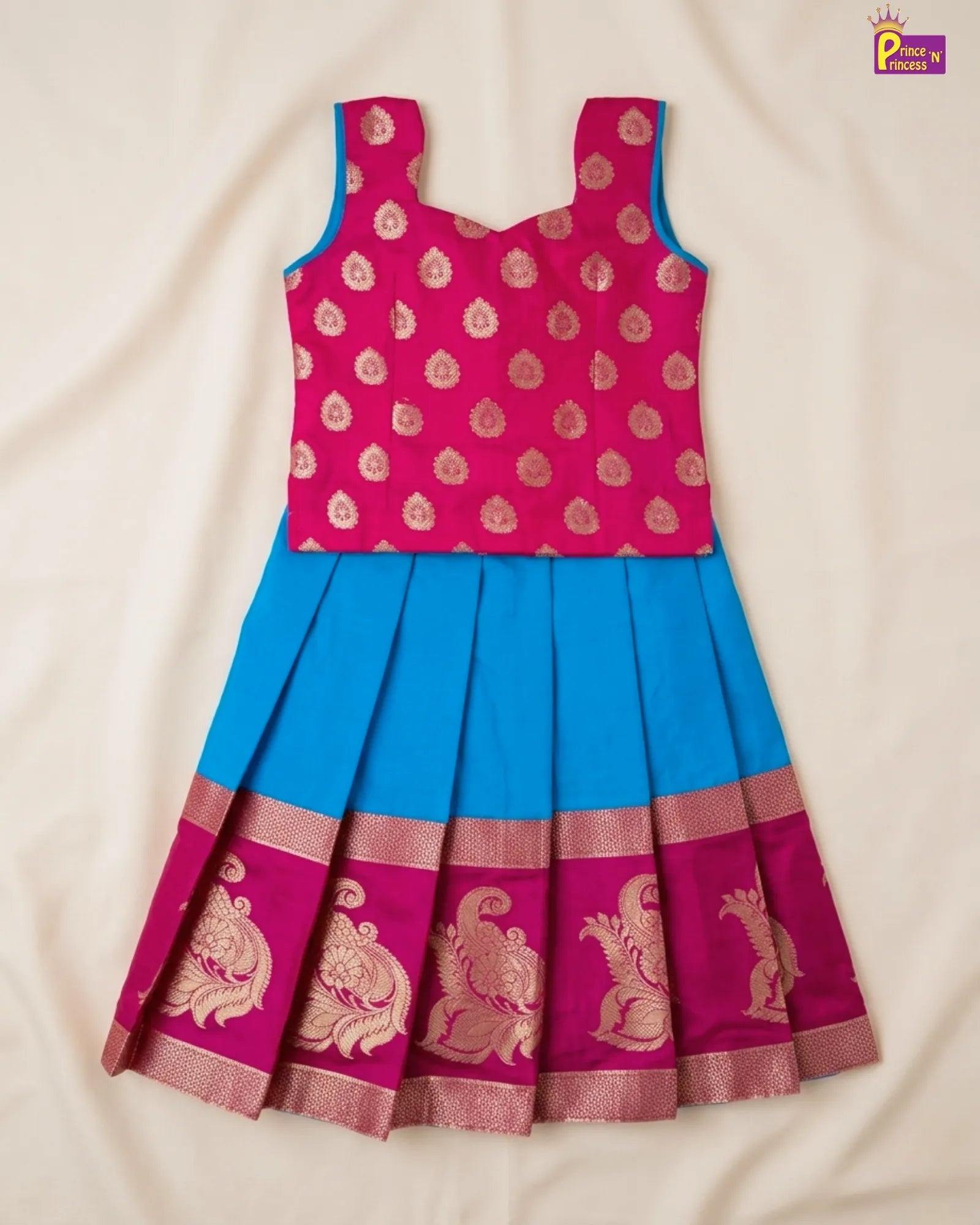 Pink and blue traditional outfit with intricate patterns on a beige background