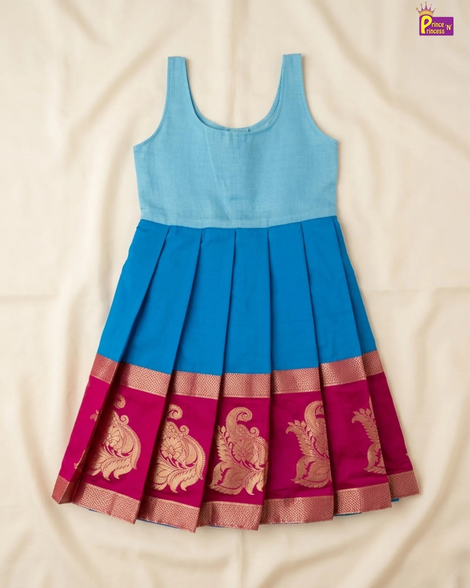 Blue and pink dress with intricate patterns on a beige background