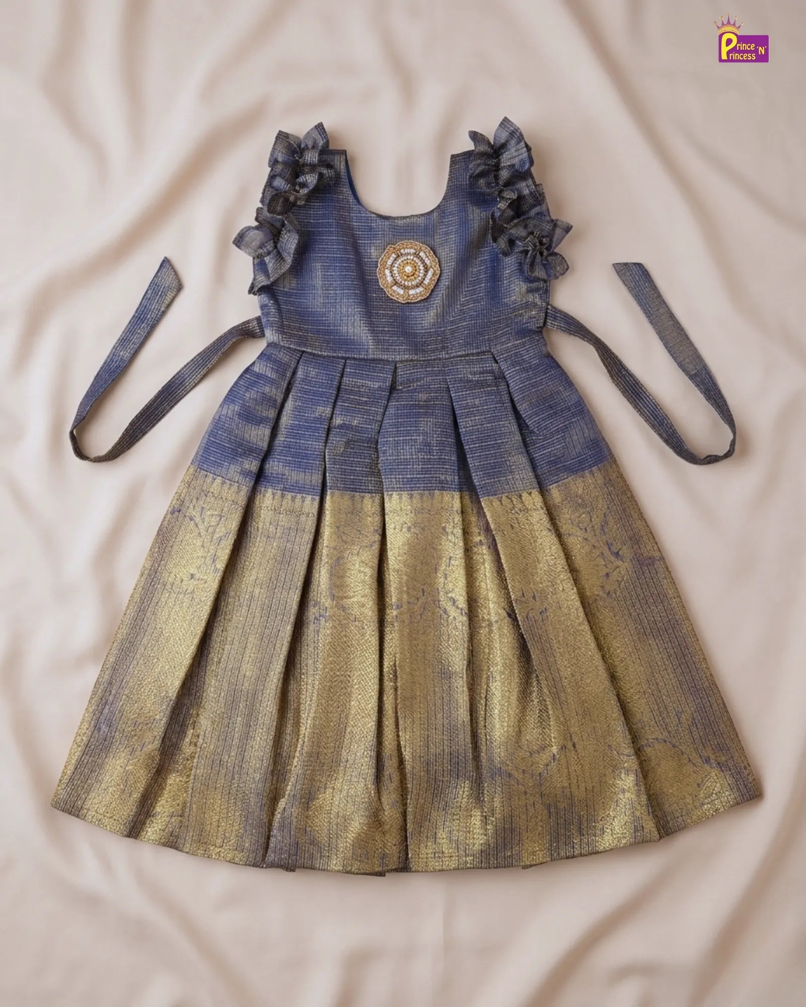 Children's dress with floral details on a beige surface