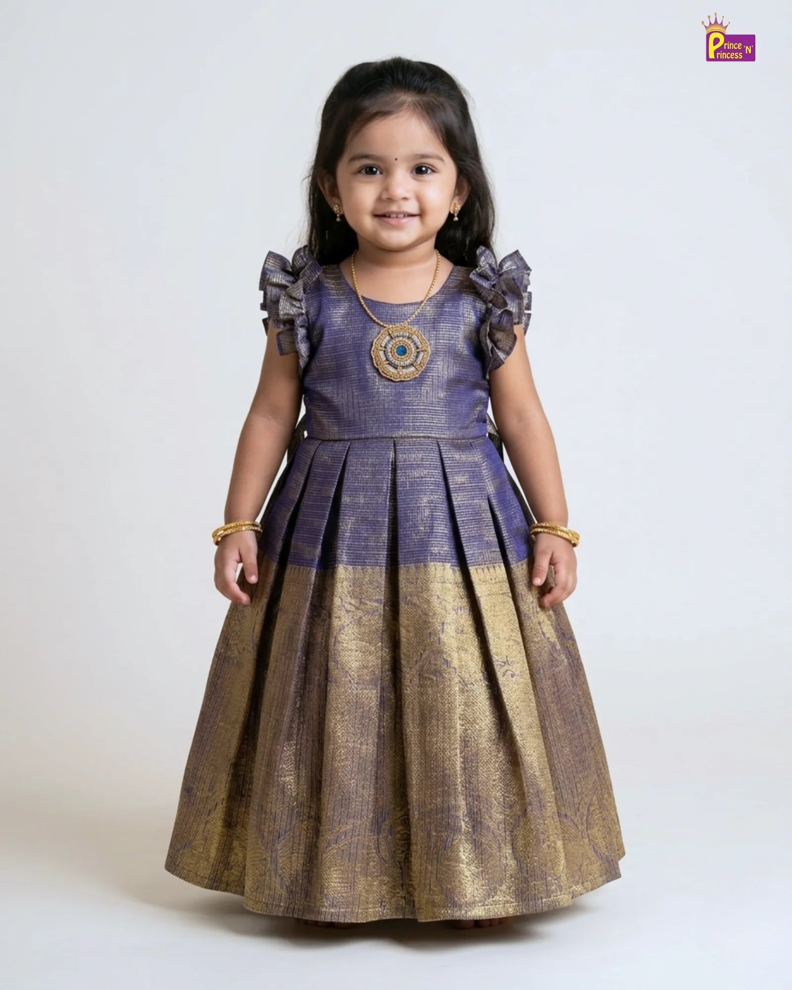 Young girl wearing a two-tone dress with a purple top and gold skirt on a white background