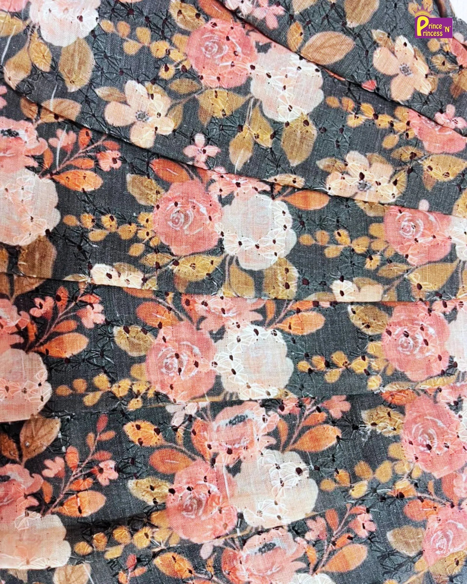 Floral patterned fabric with pink, orange, and white flowers on a dark background