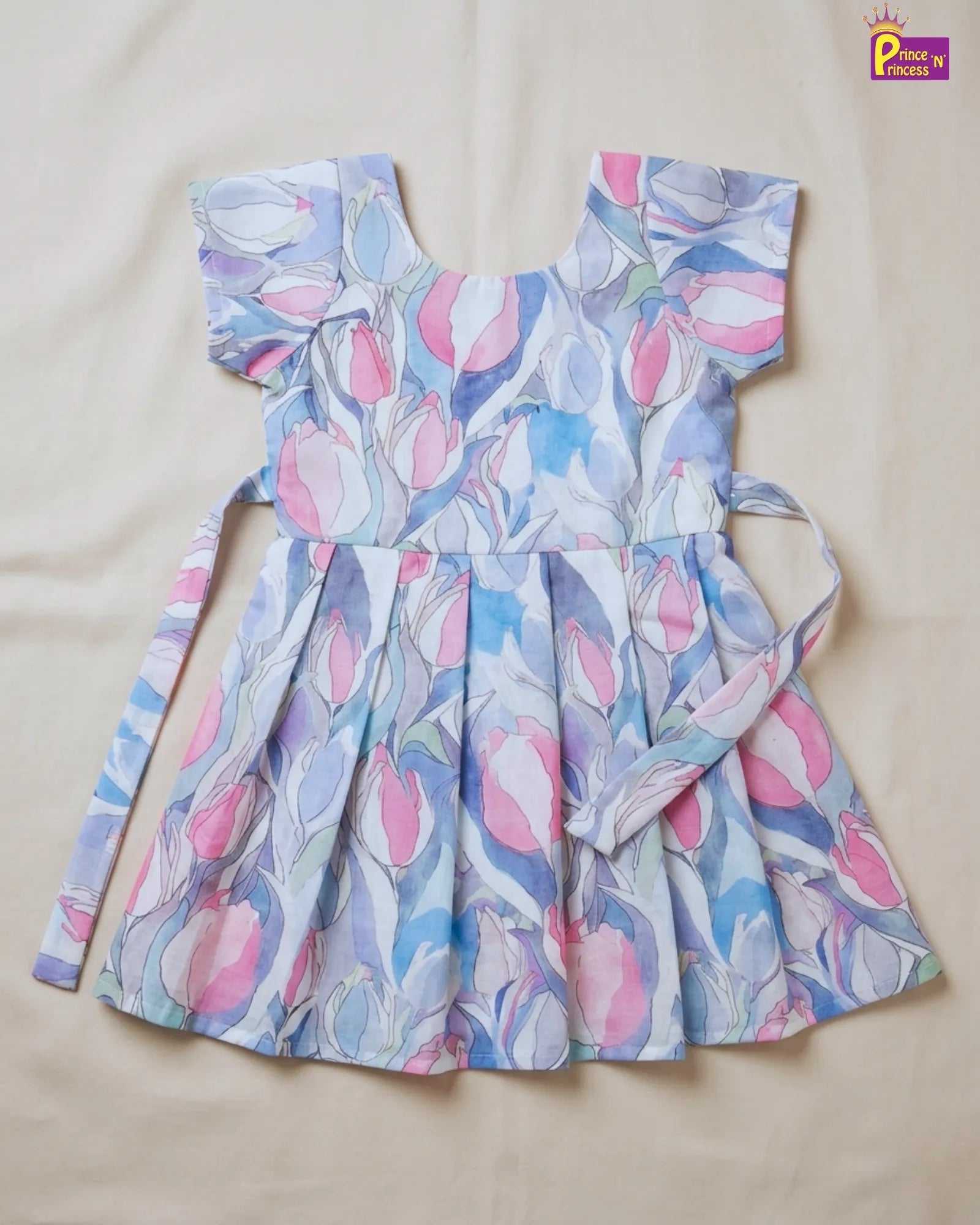 Children's dress with floral pattern on a beige background