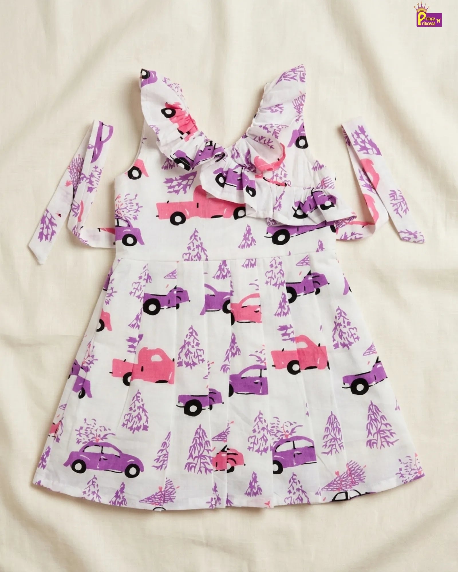 Children's dress with car pattern on a beige background