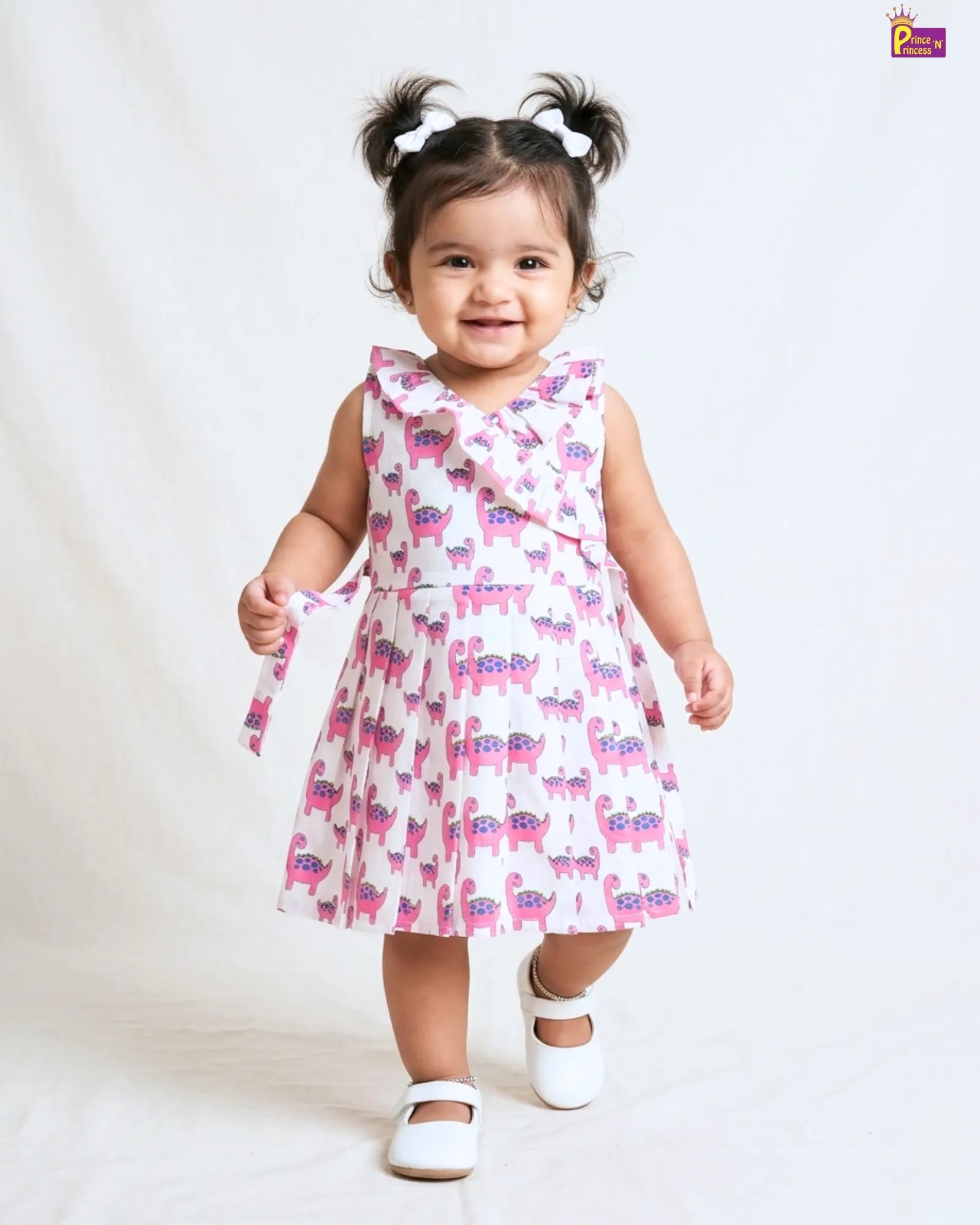 Child wearing a pink floral dress on a white background