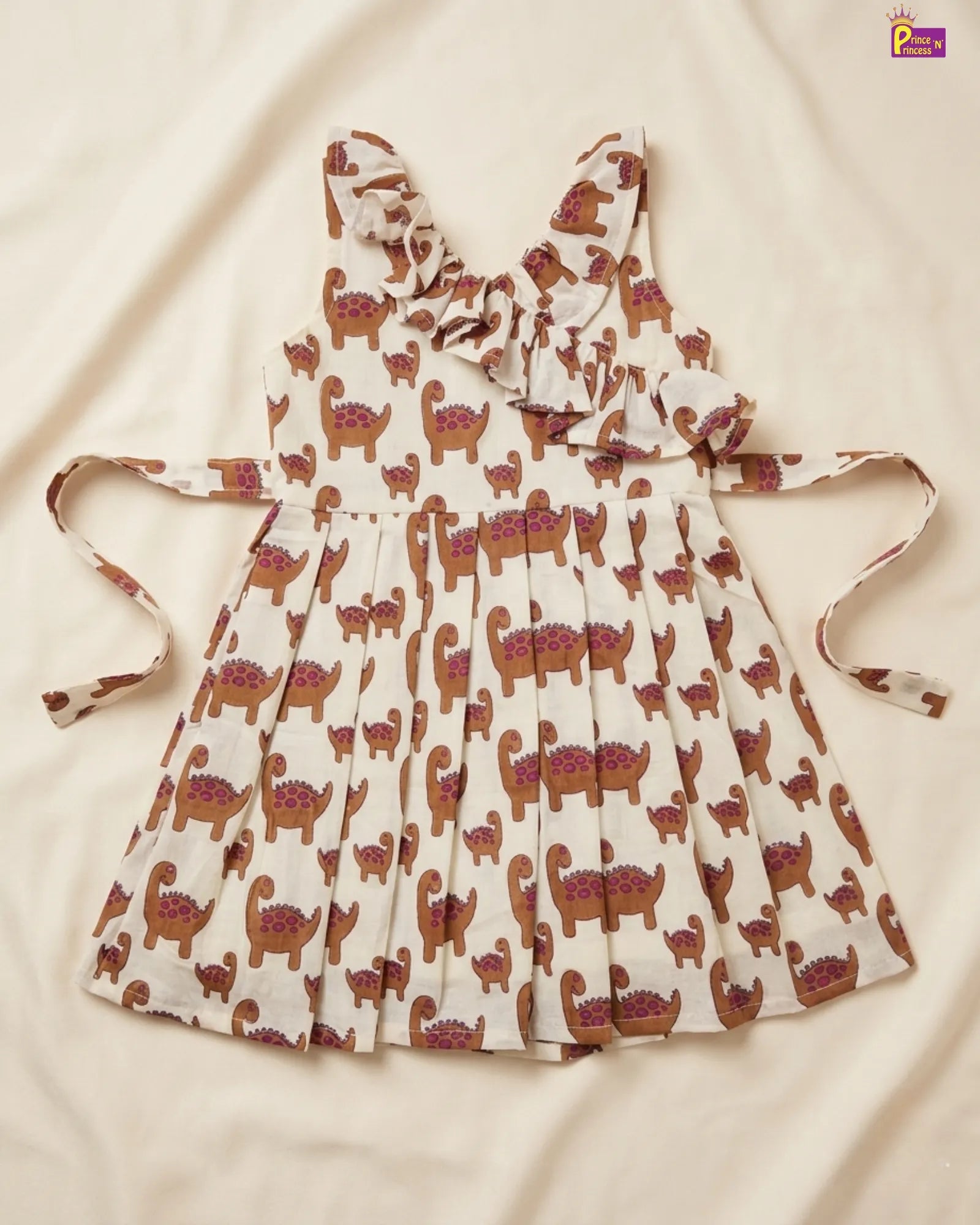 White dress with brown animal pattern on a beige background