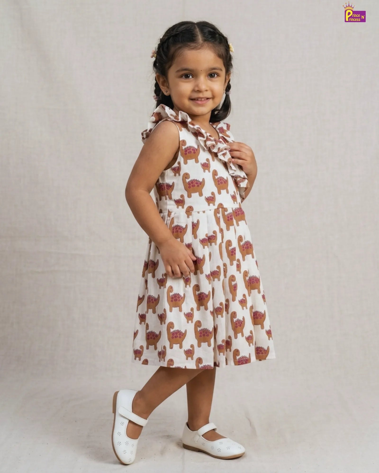 Young girl wearing a dress with animal pattern on a plain background