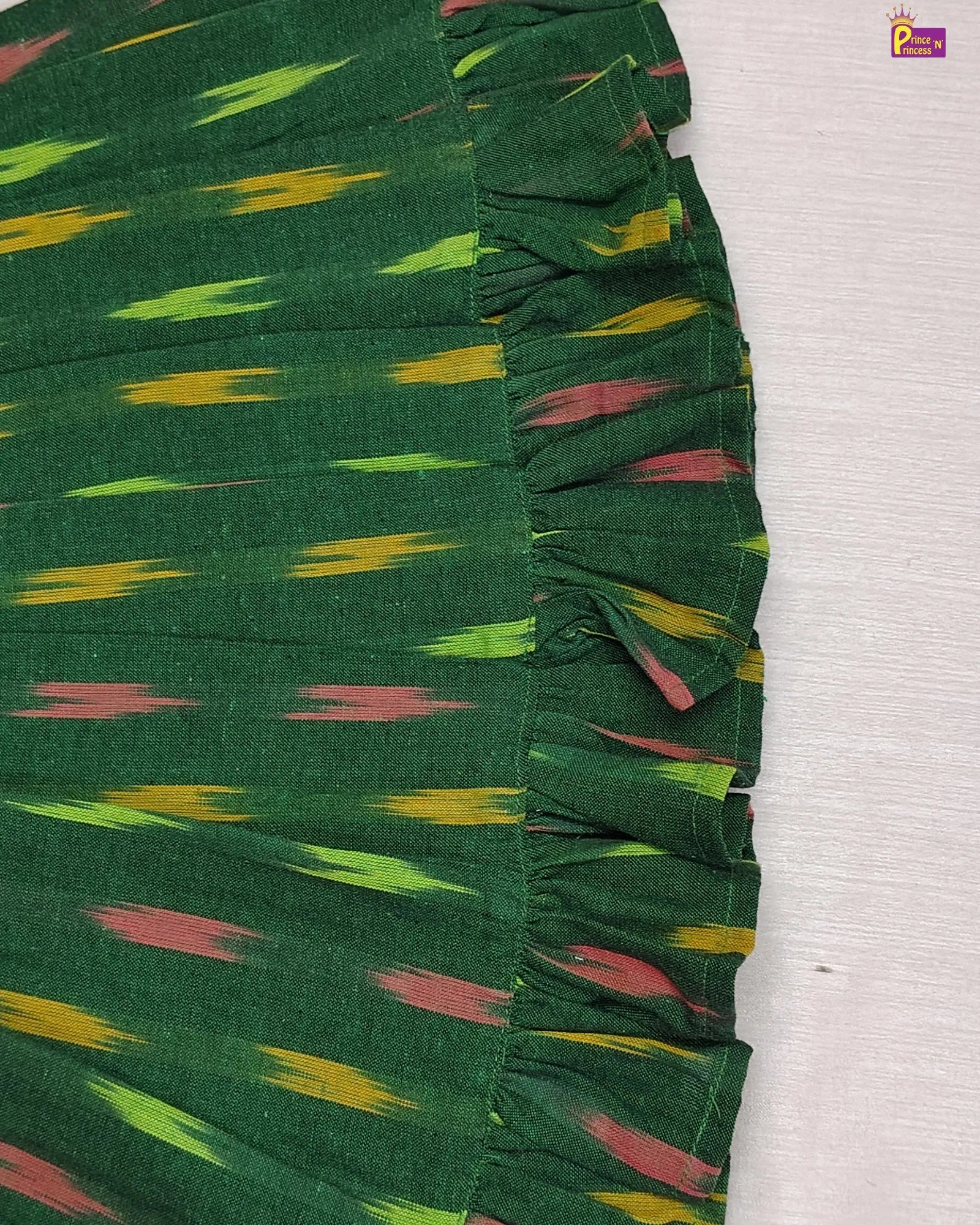 Green fabric with colorful pattern on a white background