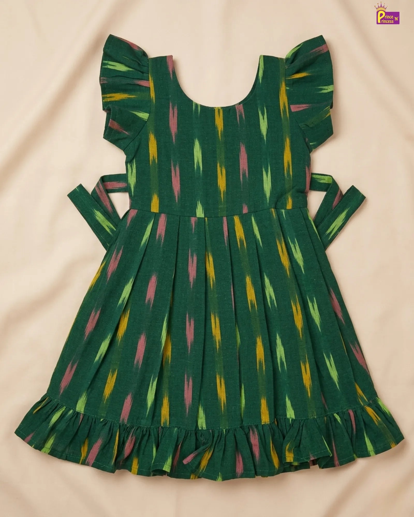 Green dress with colorful pattern on a beige background