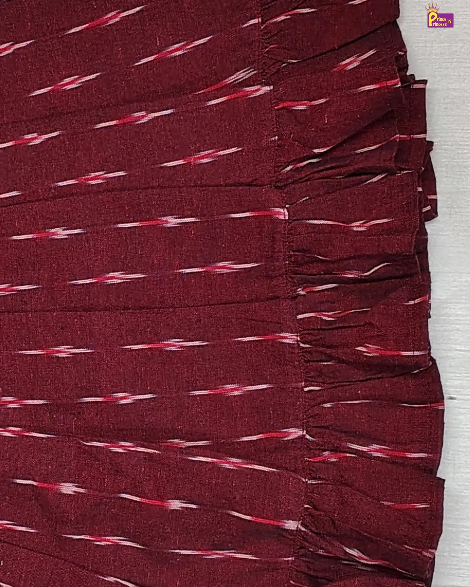 Maroon fabric with a subtle pattern on a white background